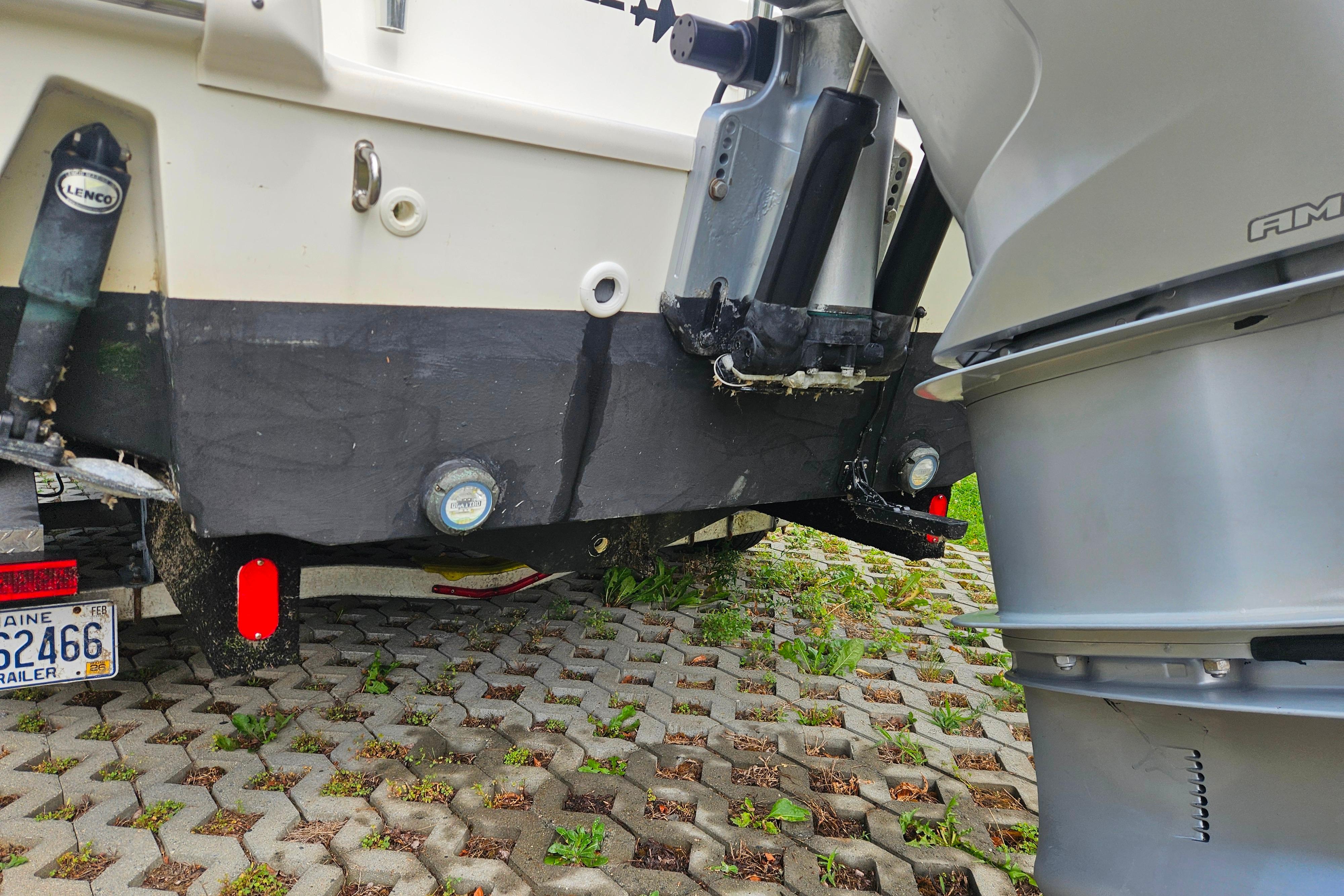 2019 Boston Whaler 230 Outrage boat stern with outboard motor and trailer.