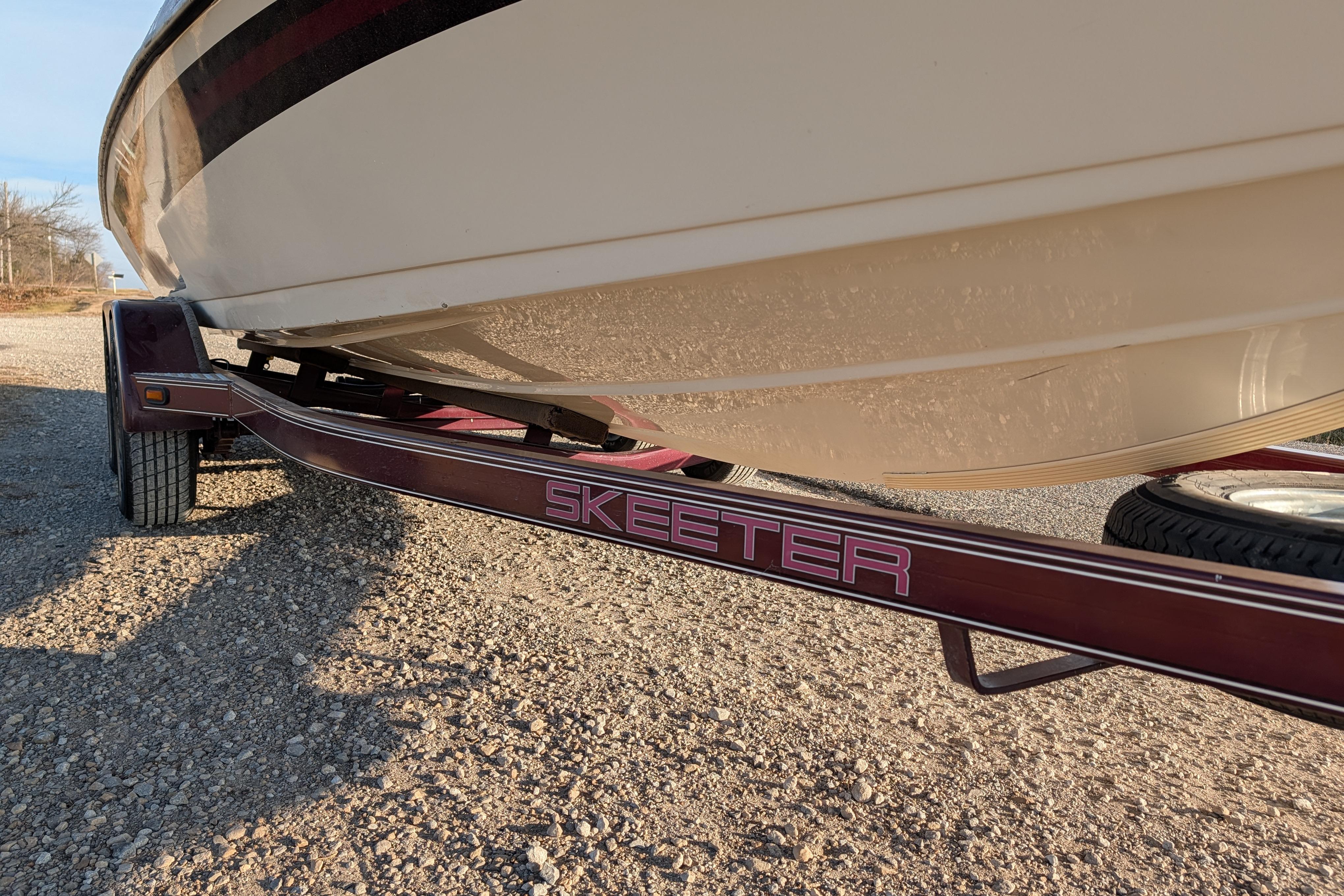 2009 Skeeter SL1900 boat on trailer, side view, sunny day.