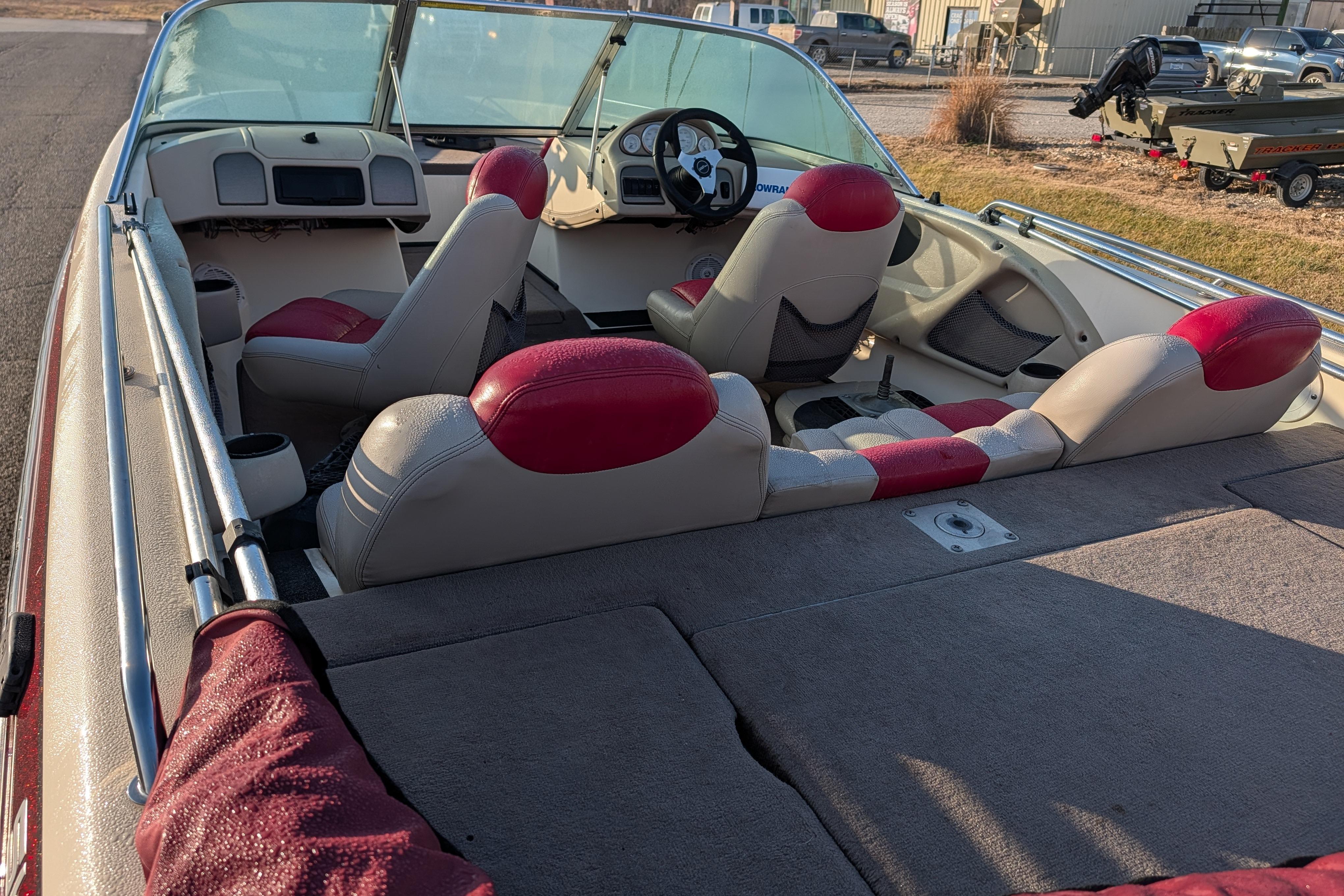 2009 Skeeter SL1900 boat interior with red and beige seating, steering wheel, and dashboard.