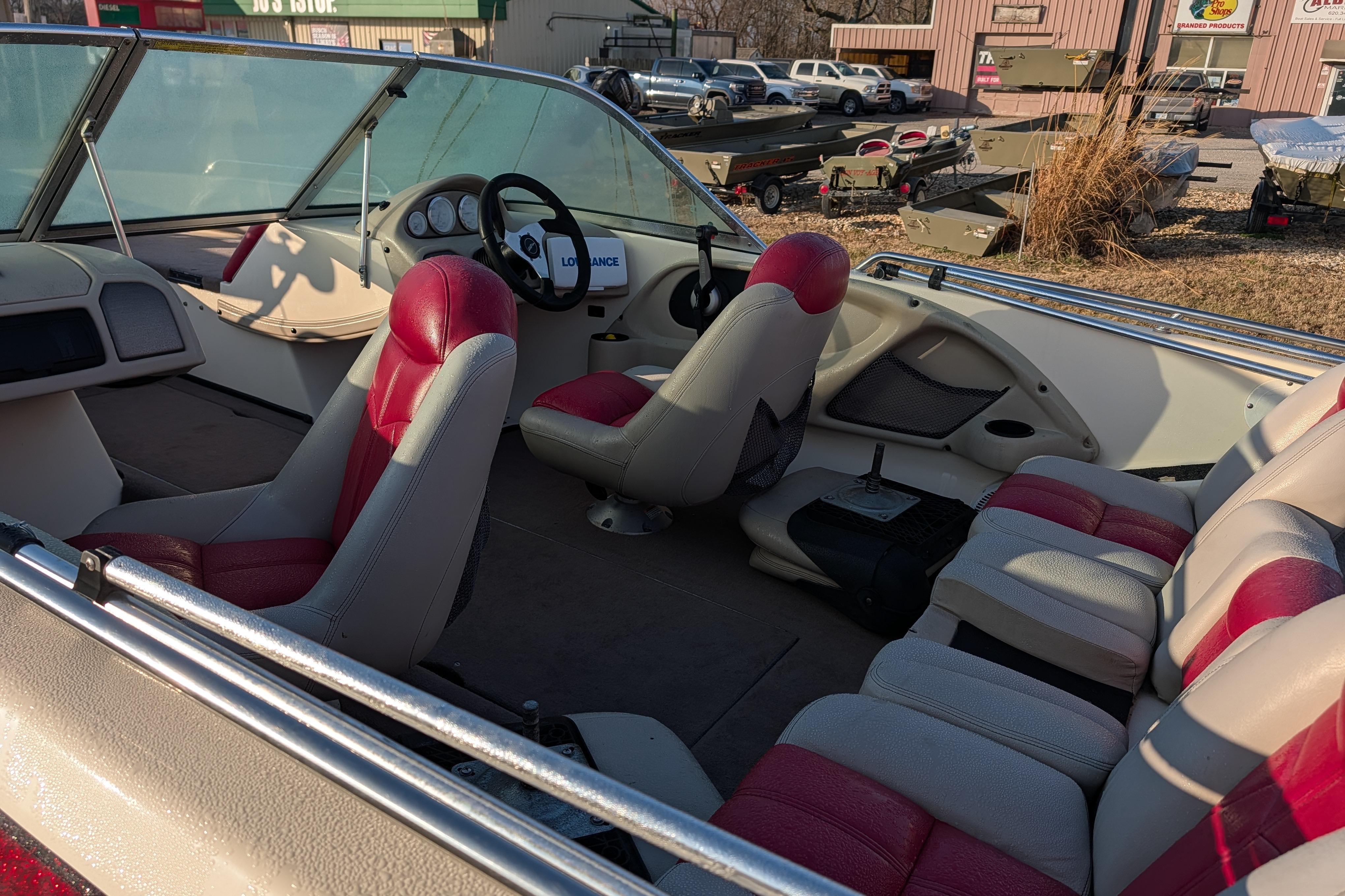 2009 Skeeter SL1900 boat interior with red and white seating, steering wheel, and dashboard.