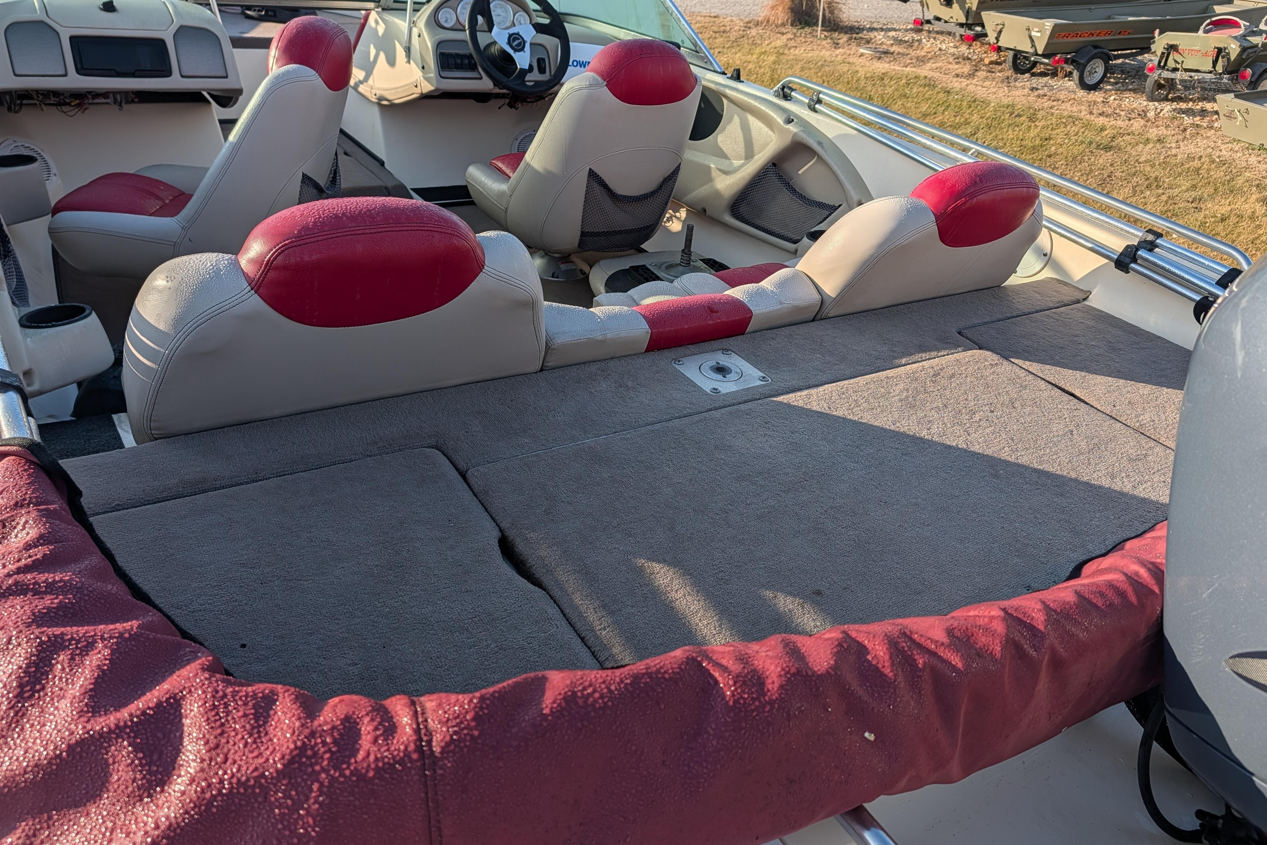 2009 Skeeter SL1900 boat interior with red and gray seating, spacious deck, and steering console.