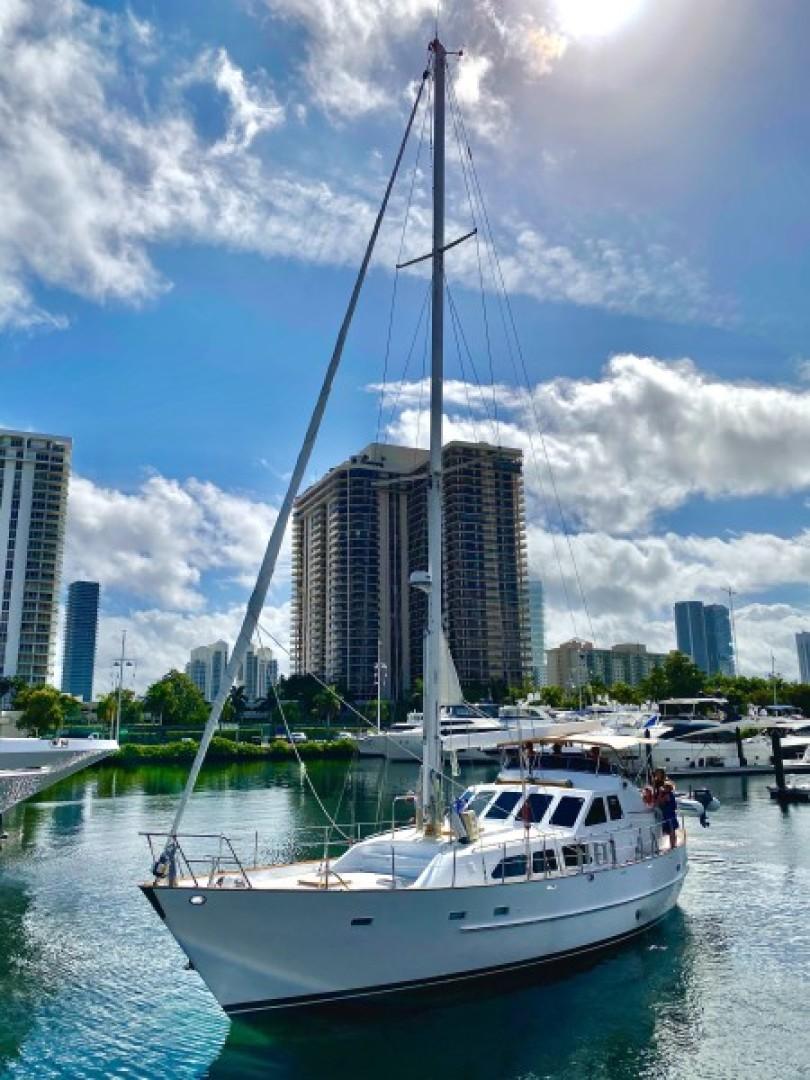 Cheoy Lee-Sloop 1990-Maraya FL-US-1990 Cheoy Lee Sloop sailing near modern city skyline under blue sky.-9808426