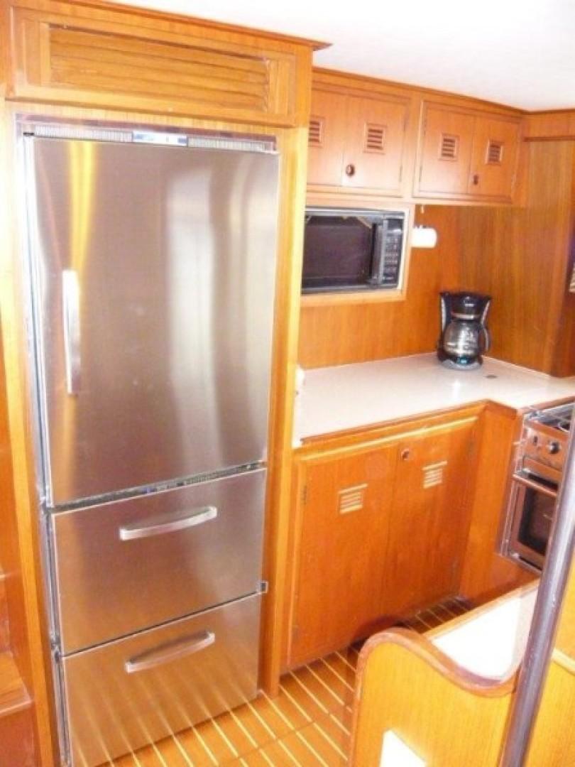 Cheoy Lee-Sloop 1990-Maraya FL-US-1990 Cheoy Lee Sloop kitchen with stainless steel fridge, wooden cabinets, and modern appliances.-9808426 | Thumbnail