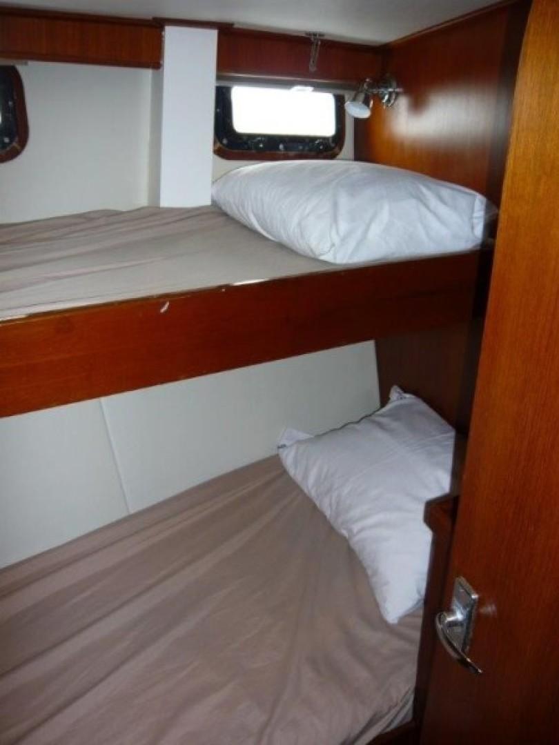 Cheoy Lee-Sloop 1990-Maraya FL-US-1990 Cheoy Lee Sloop cabin with wooden bunk beds and porthole window.-9808426 | Thumbnail