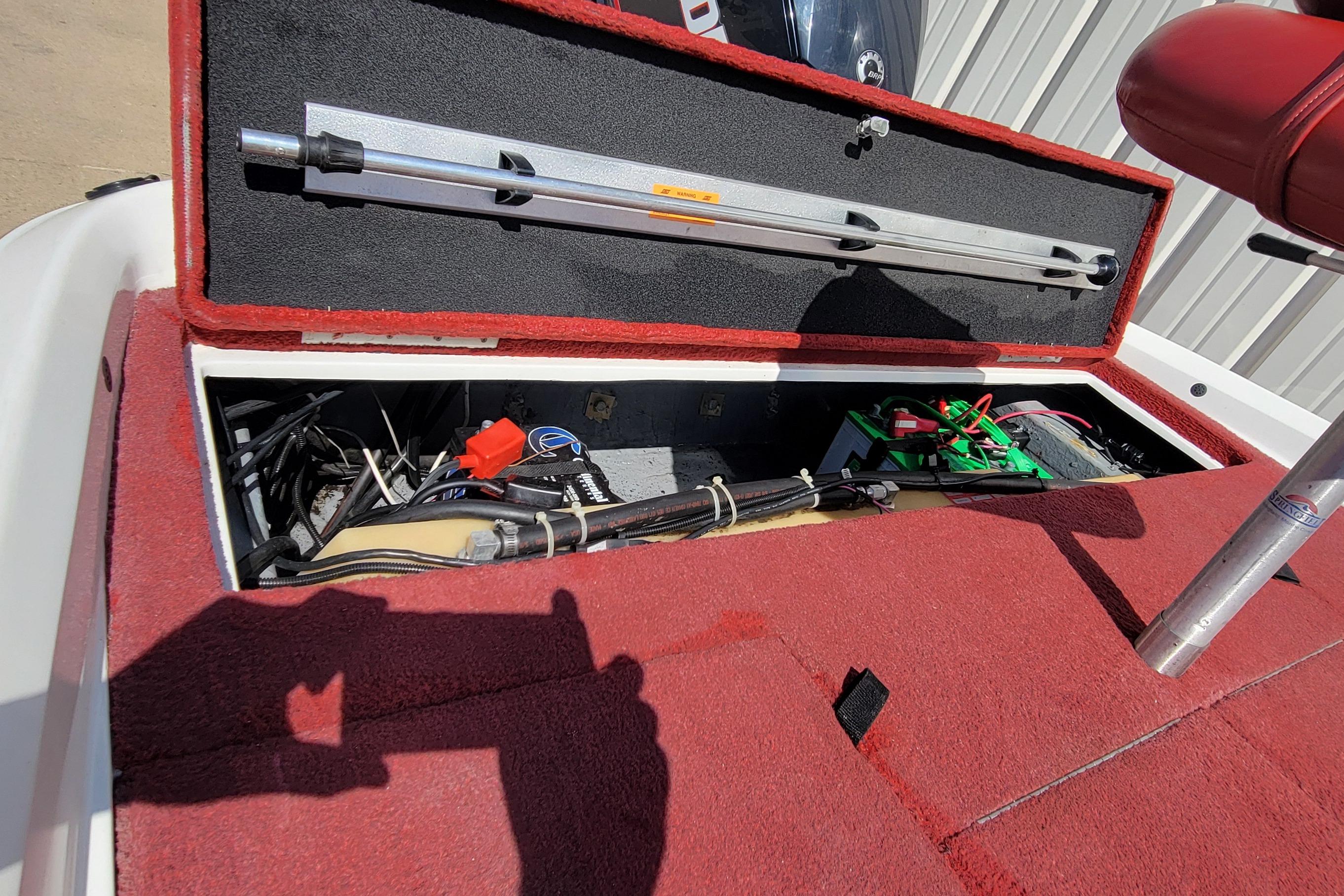 Open storage compartment in 2000 Nitro 640LX boat, showing wiring and equipment.