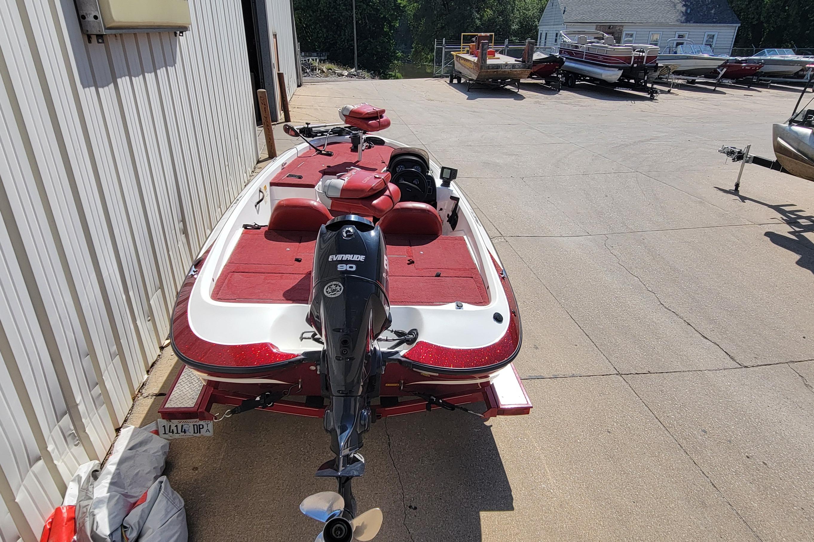 2000 Nitro 640LX boat with Evinrude 90 engine, parked outdoors.
