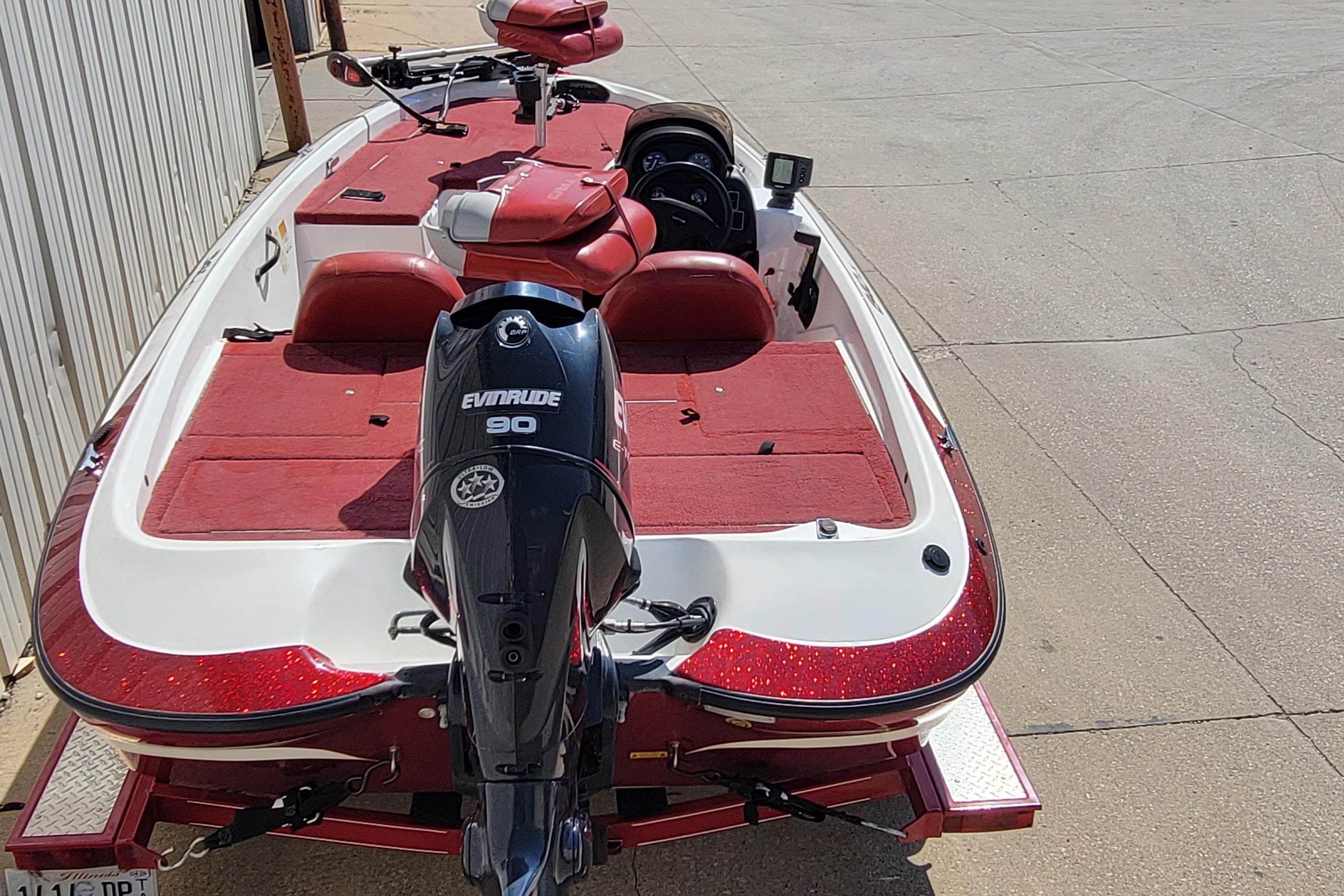 Red and white 2000 Nitro 640LX boat with Evinrude 90 engine on trailer.