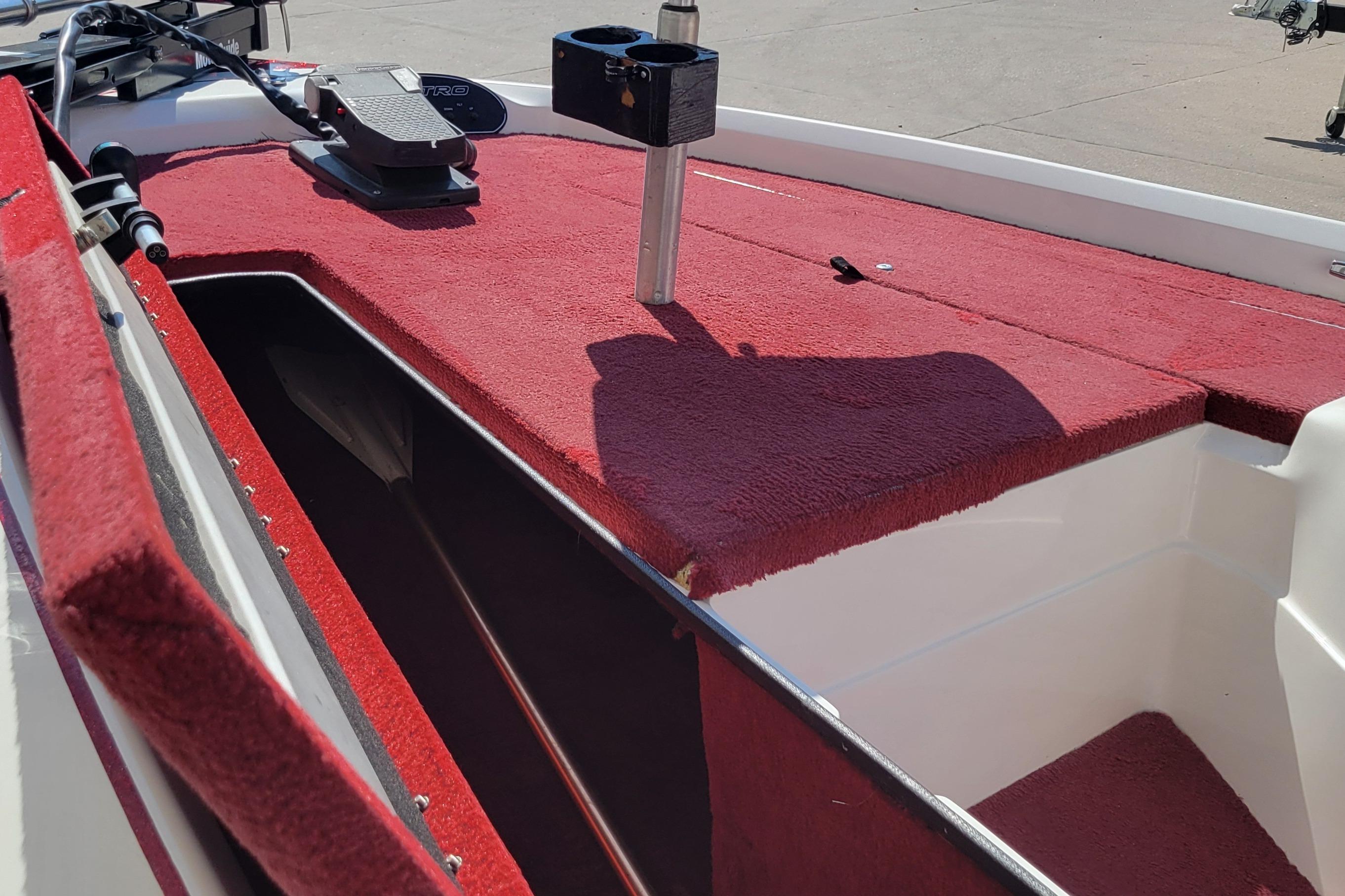 2000 Nitro 640LX boat interior with red carpet and storage compartment.