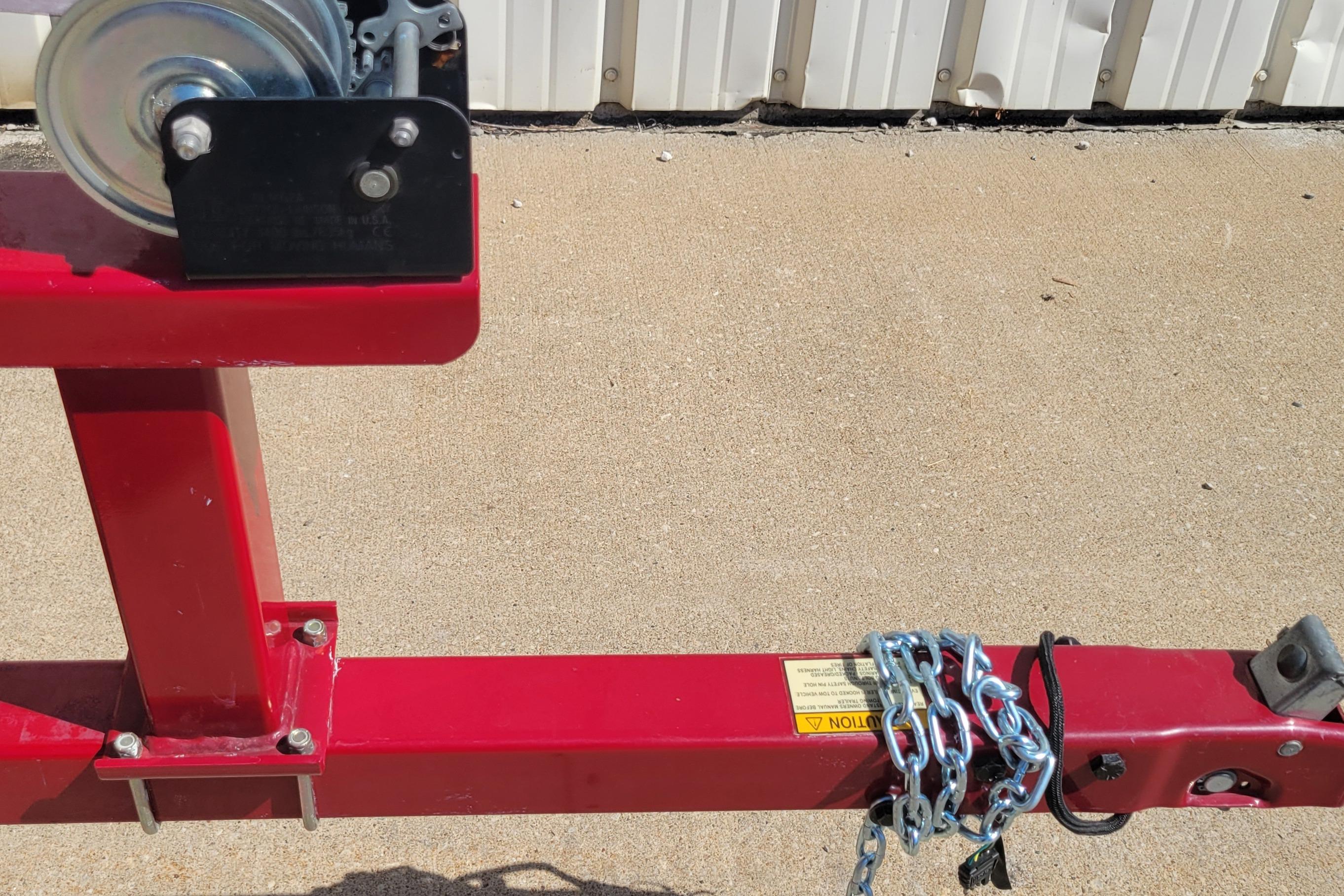 Red Nitro 640LX trailer hitch with chains, 2000 model, on concrete surface.