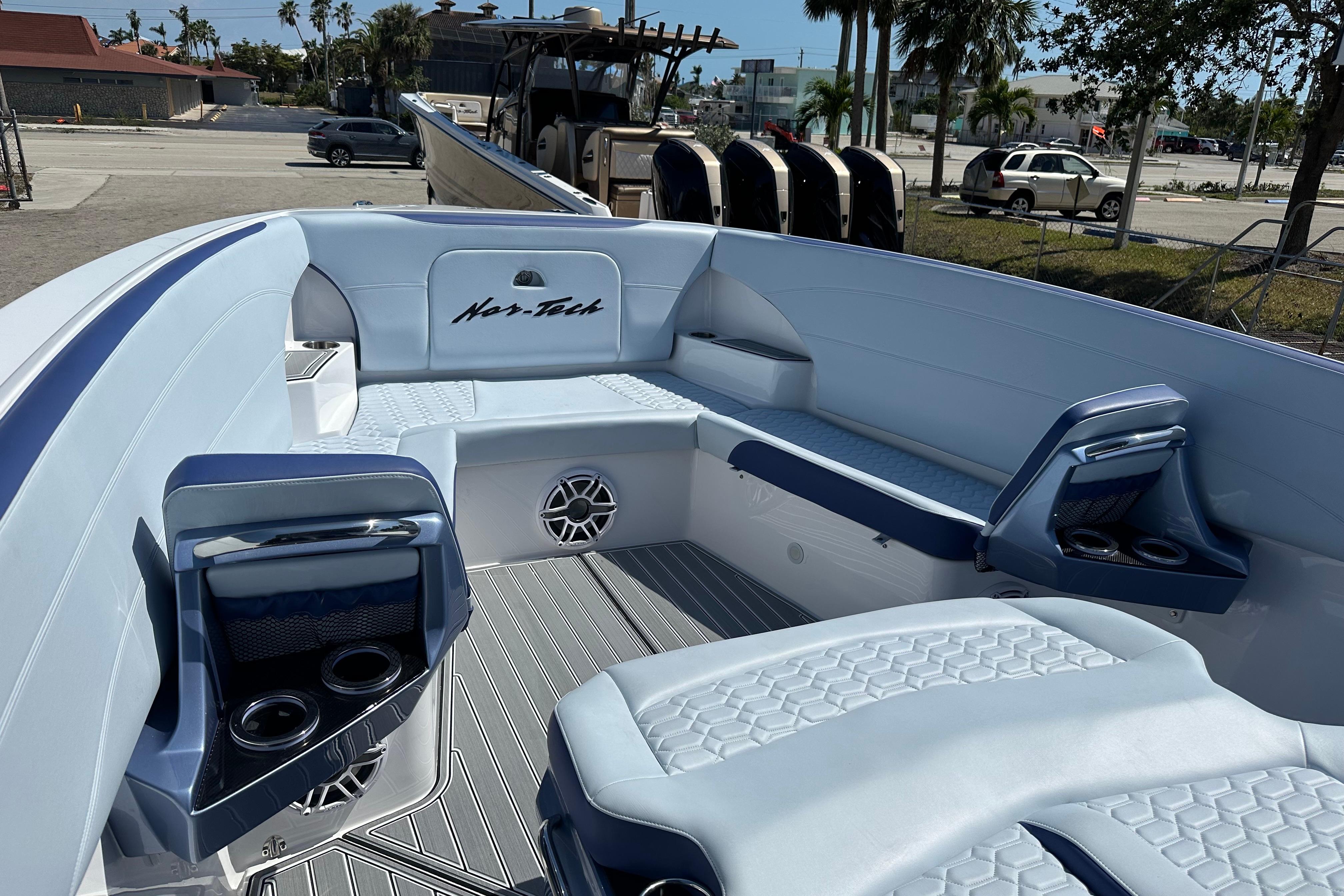 2024 Nor-Tech 340 Sport Center Console boat interior with seating and cup holders.