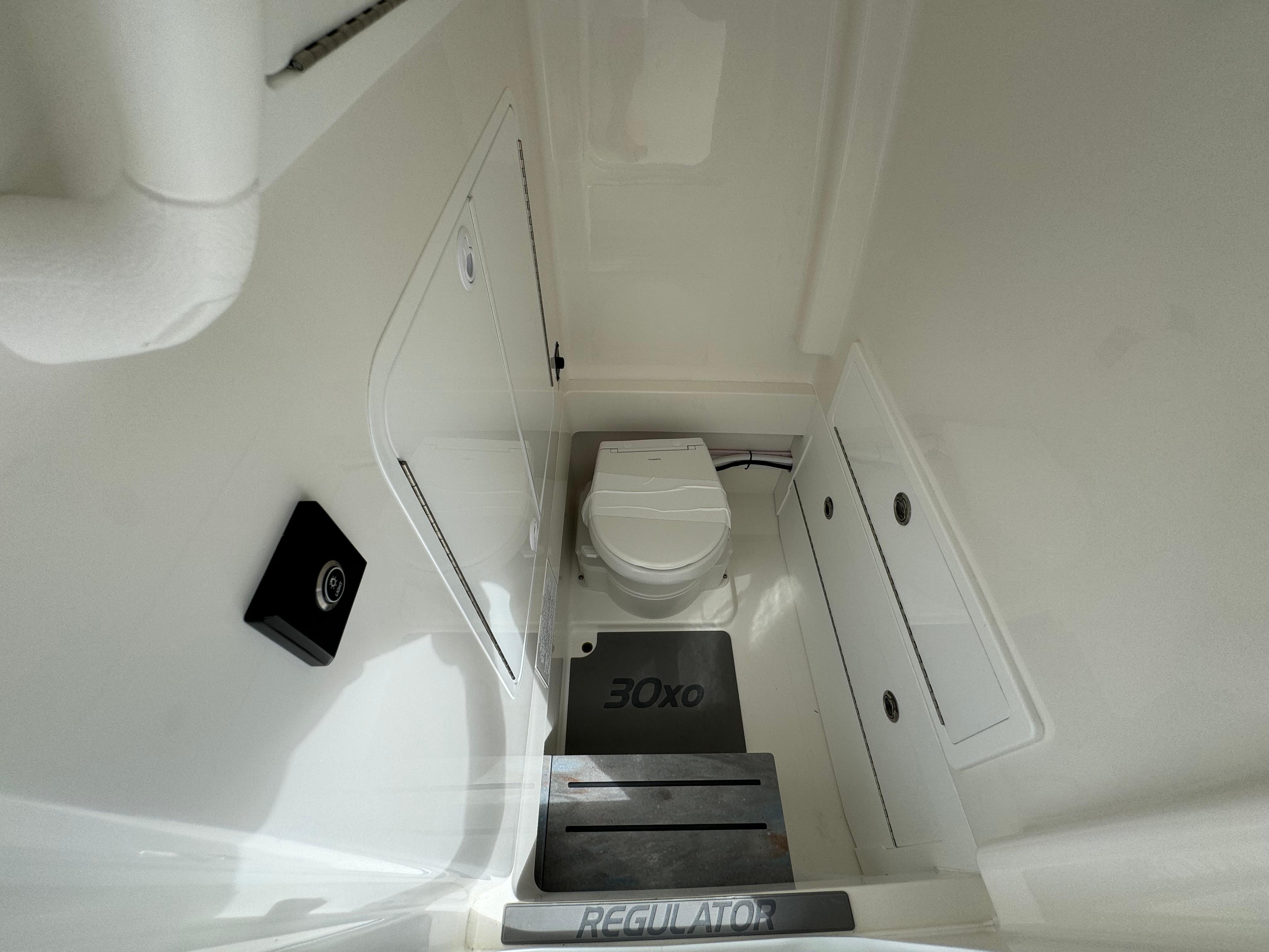 Regulator-30XO 2024-STORM GRAY MA-US-2024 Regulator 30XO boat interior with toilet and storage compartments.-9692464 | Thumbnail