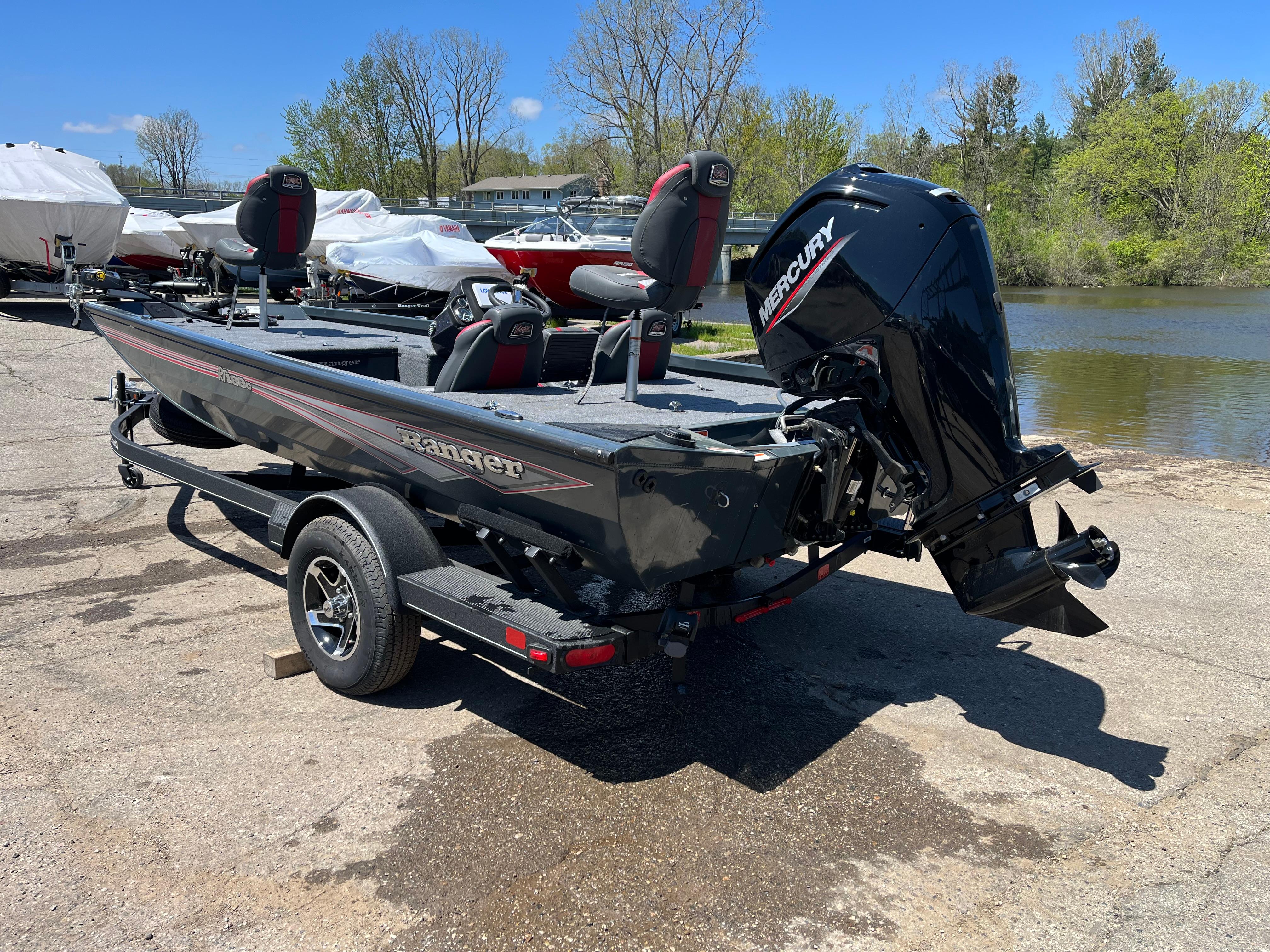 2024 Ranger RT188C fishing boat with Mercury engine, parked near a lake.