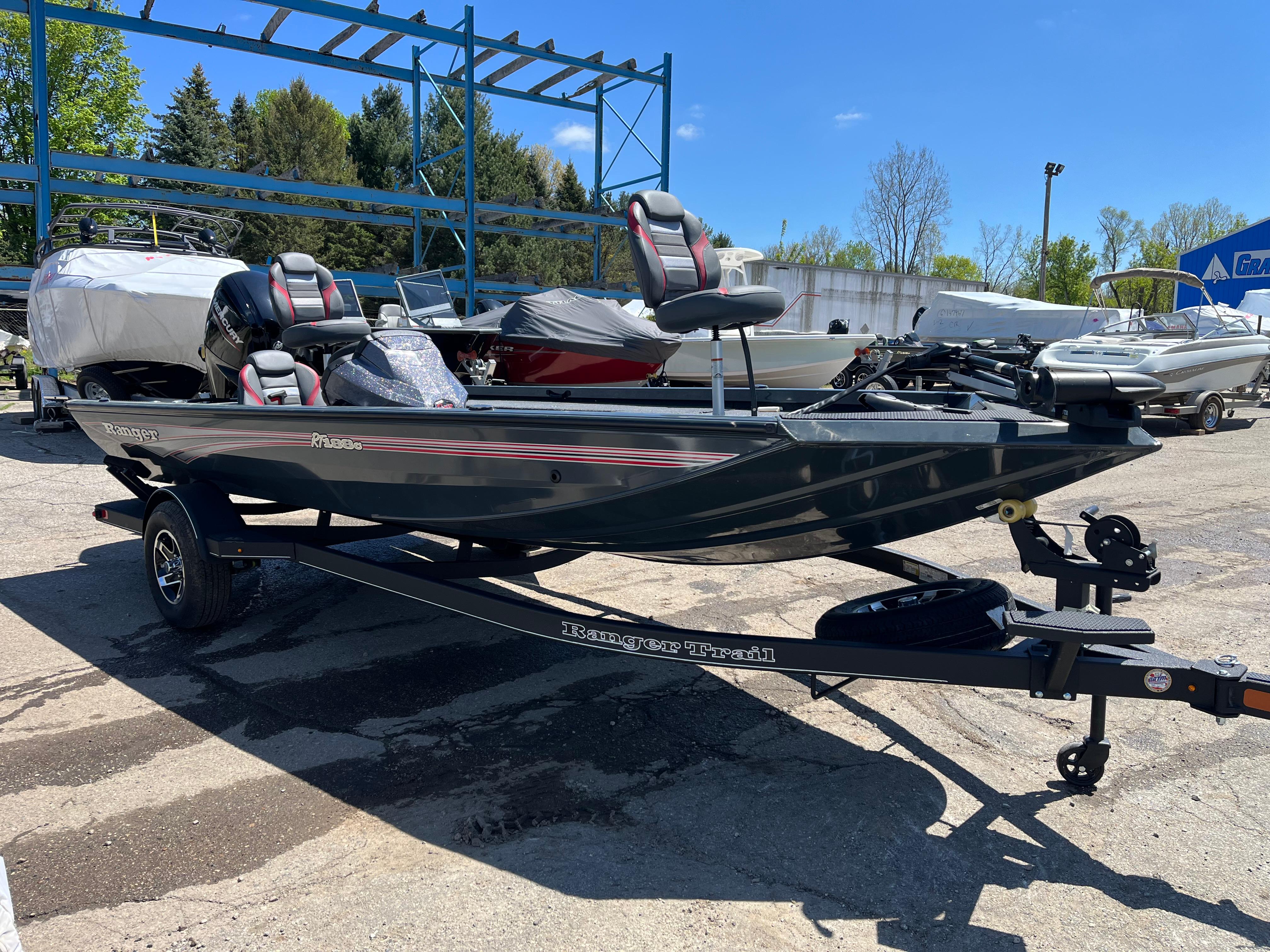 2024 Ranger RT188C fishing boat on trailer, parked outdoors.