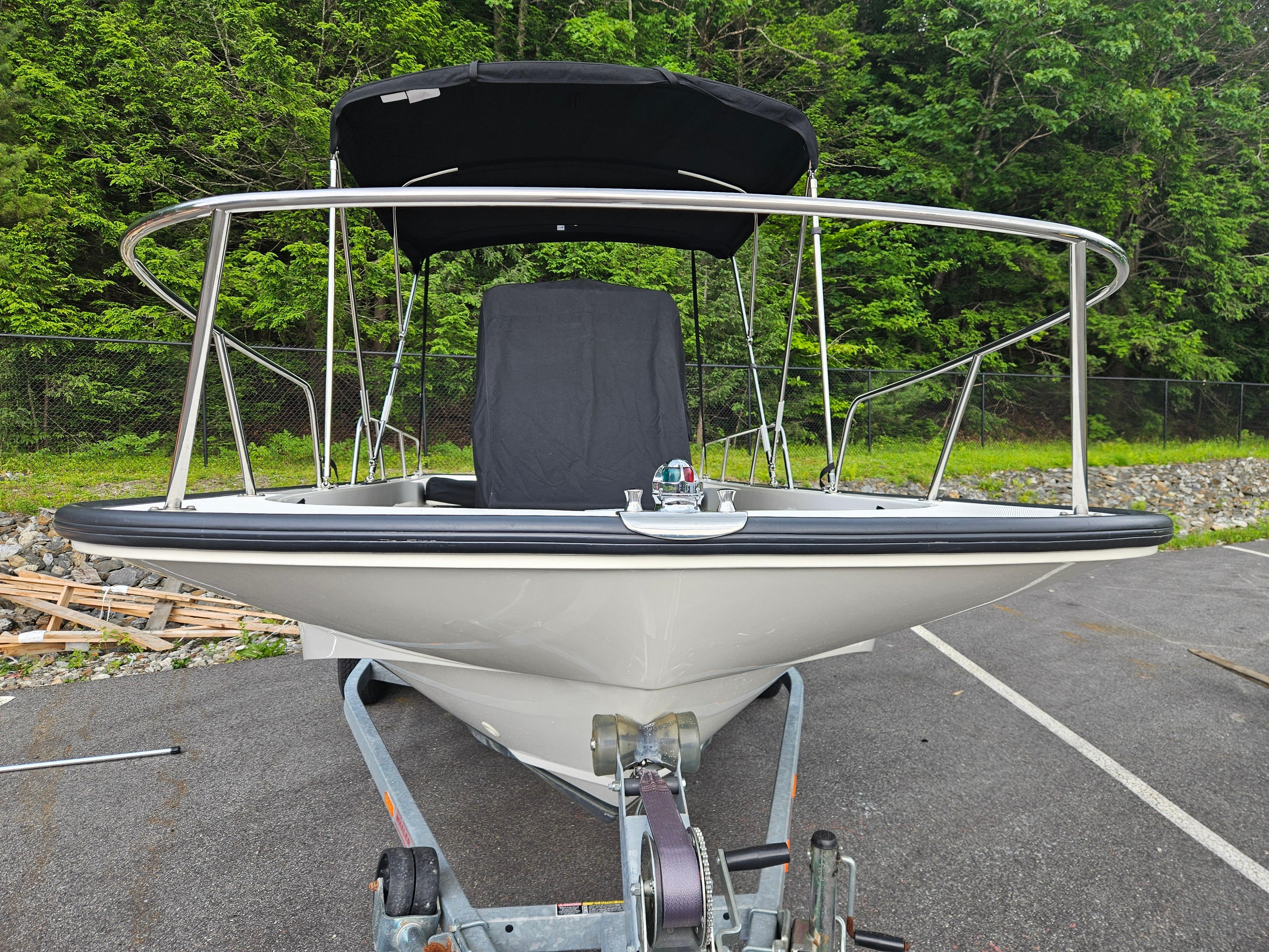 2008 Boston Whaler 170 Montauk boat on trailer, surrounded by greenery.