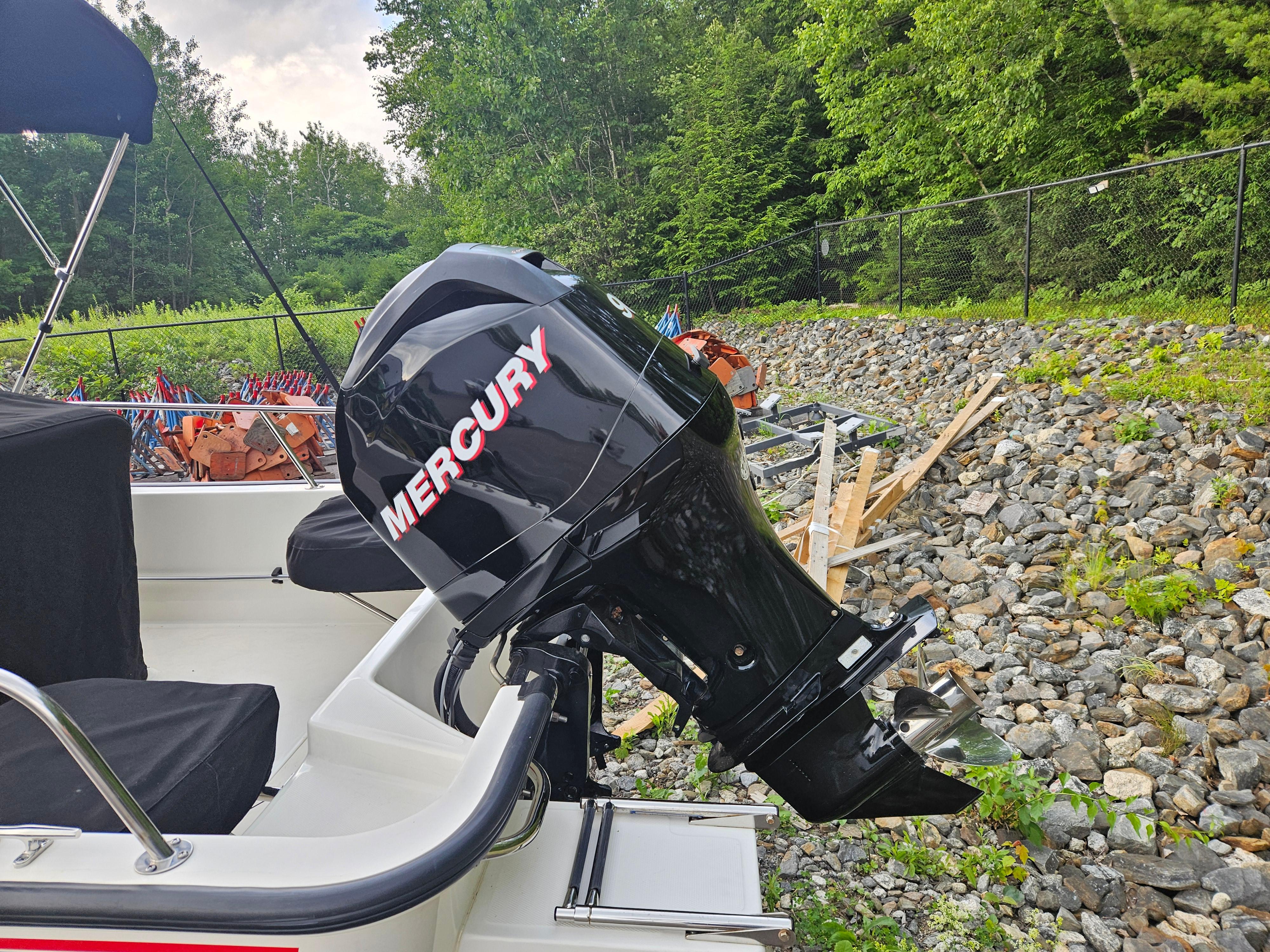2008 Boston Whaler 170 Montauk with Mercury outboard motor, parked on rocky terrain.