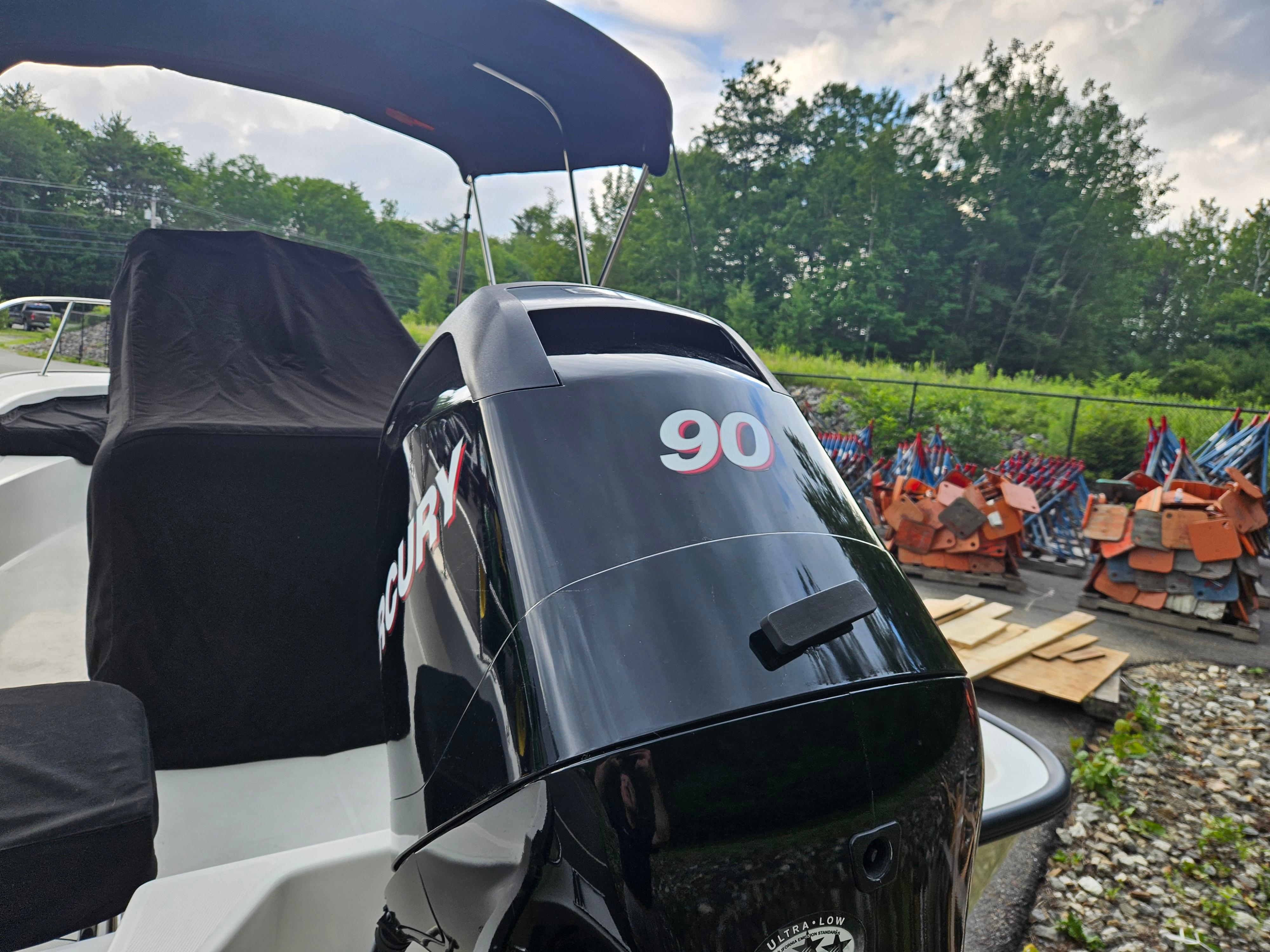 2008 Boston Whaler 170 Montauk with Mercury 90 outboard engine, parked outdoors.