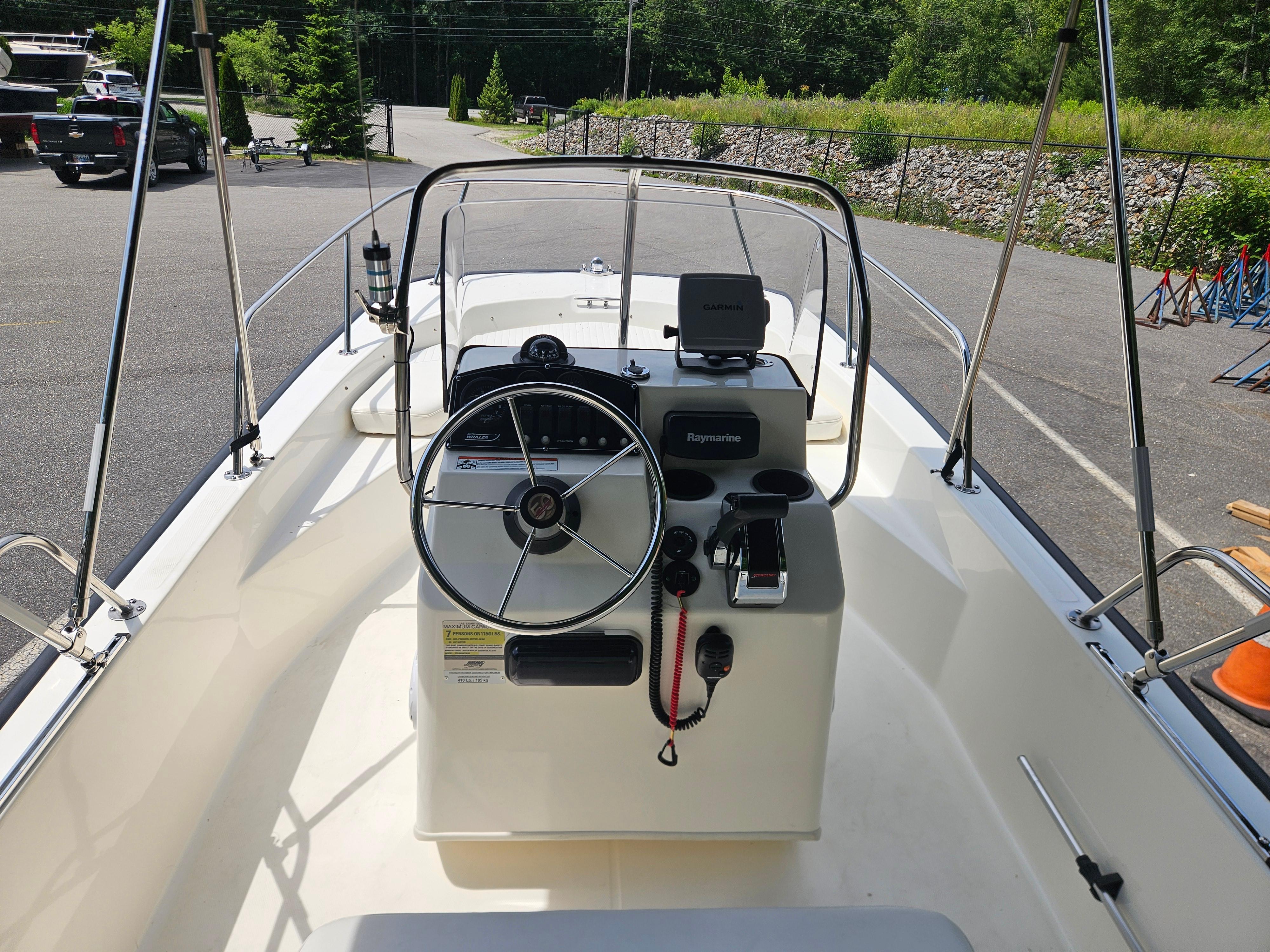 2008 Boston Whaler 170 Montauk boat interior with steering wheel and navigation equipment.