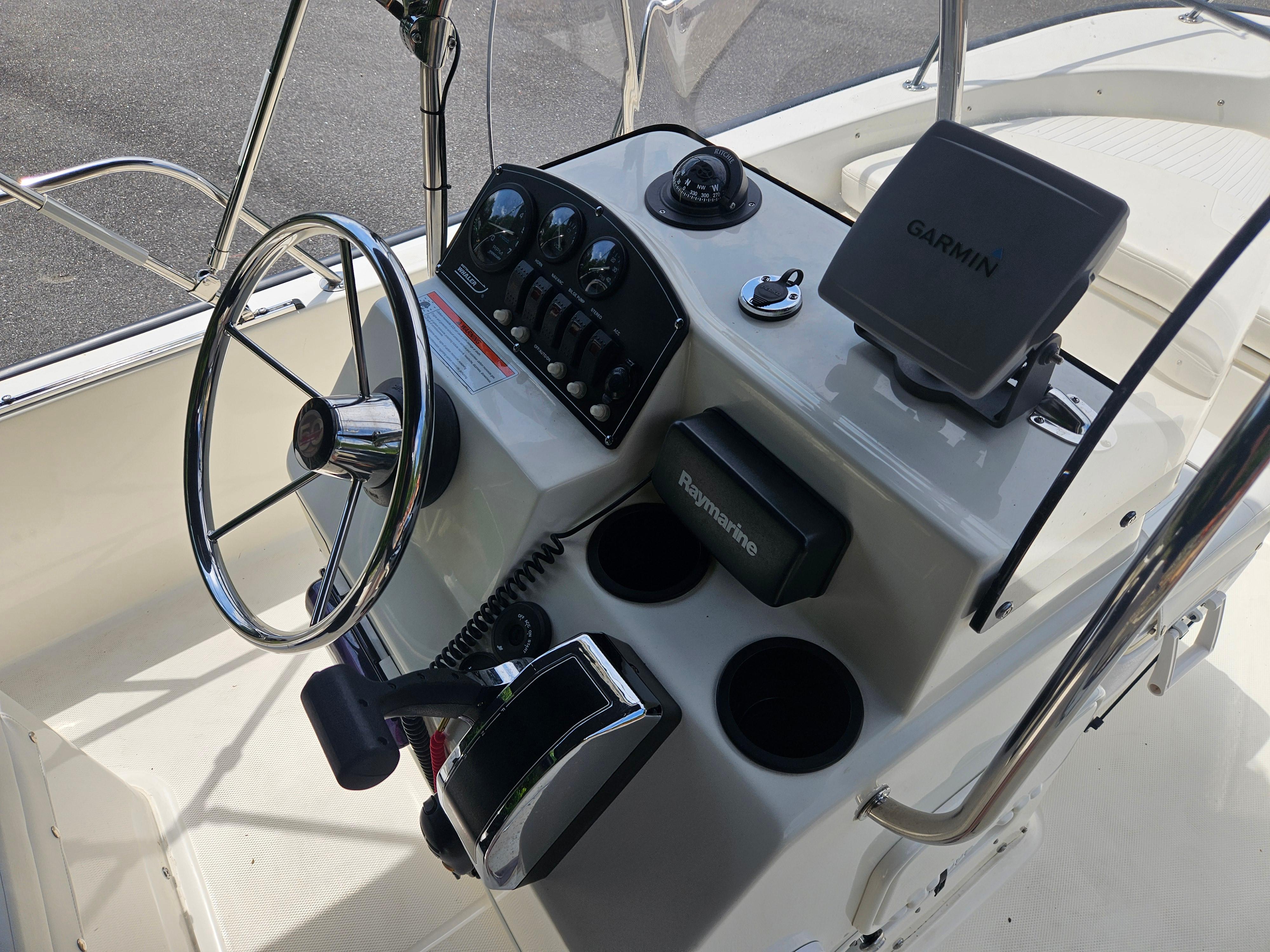 2008 Boston Whaler 170 Montauk boat console with steering wheel, Garmin and Raymarine devices.