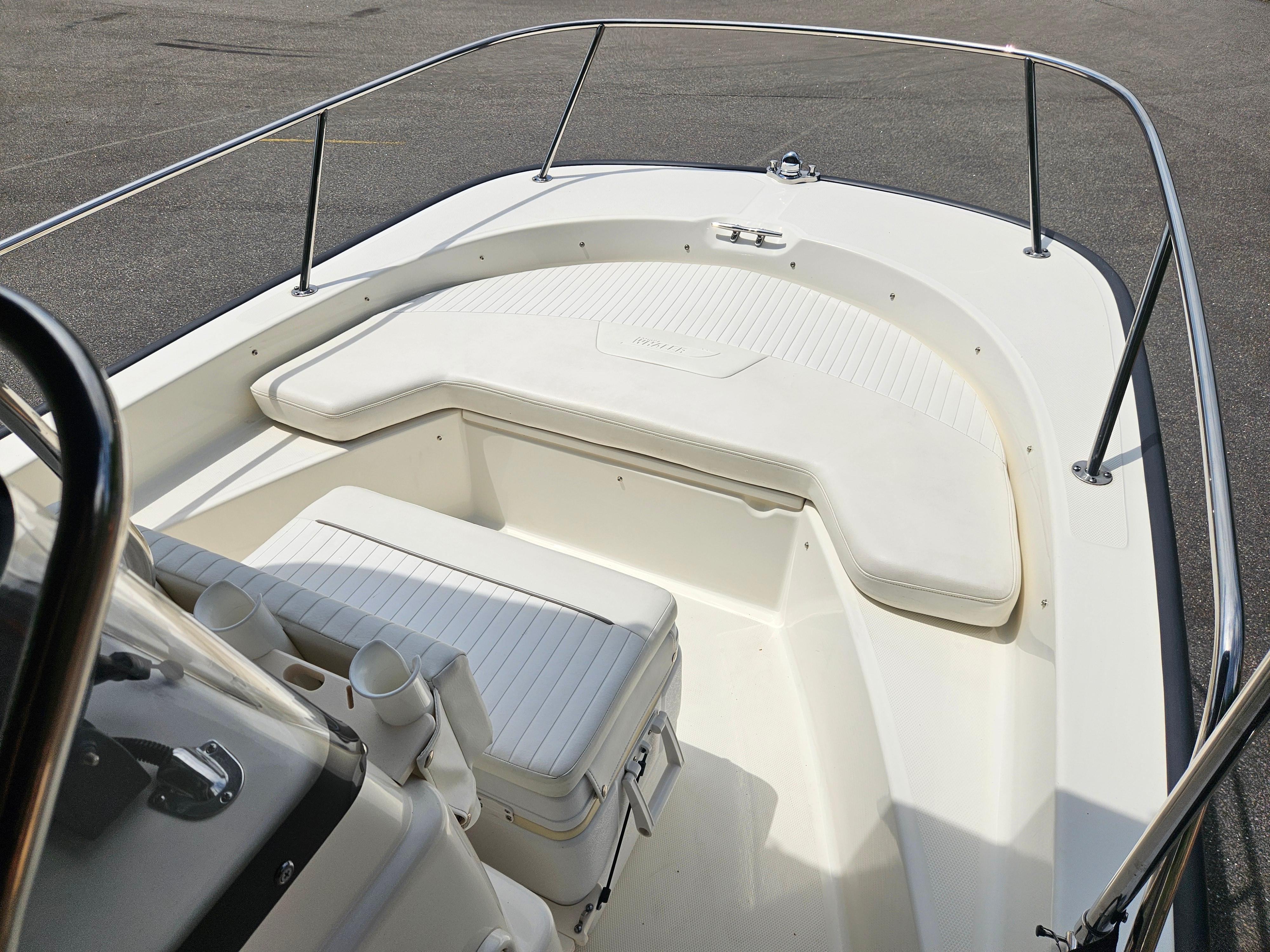 2008 Boston Whaler 170 Montauk boat interior with cushioned seating and stainless steel railings.