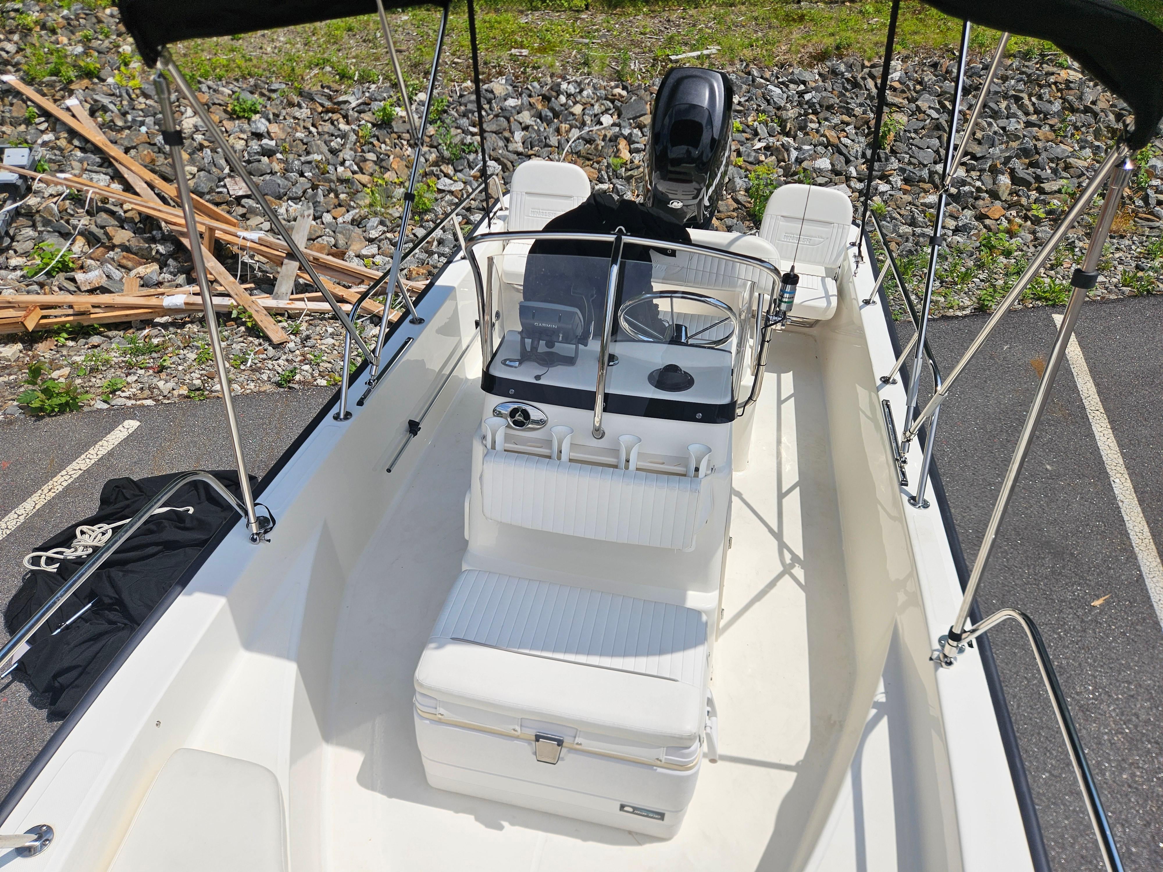 2008 Boston Whaler 170 Montauk boat interior with seating and steering console.