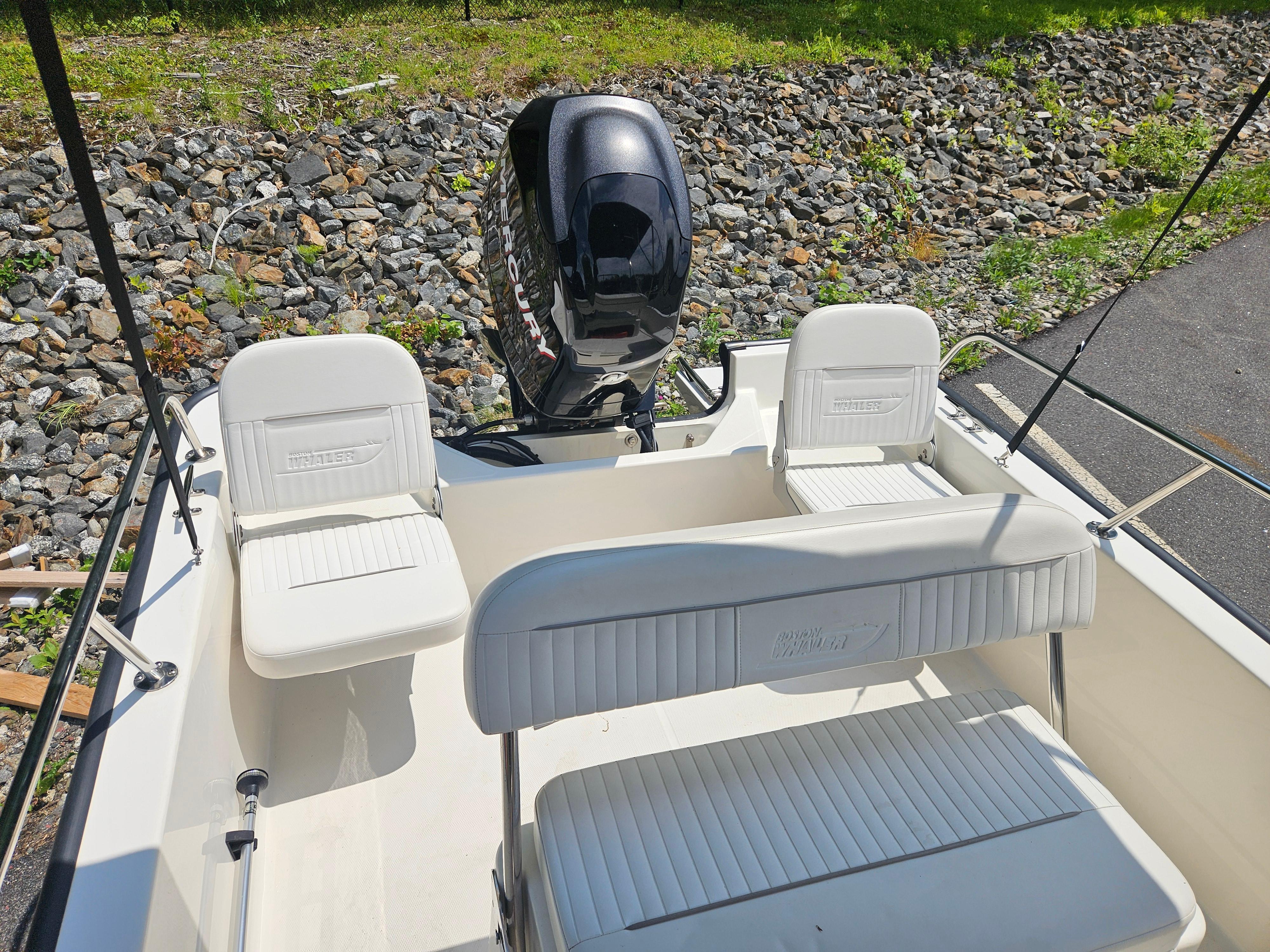 2008 Boston Whaler 170 Montauk boat interior with seating and outboard motor.