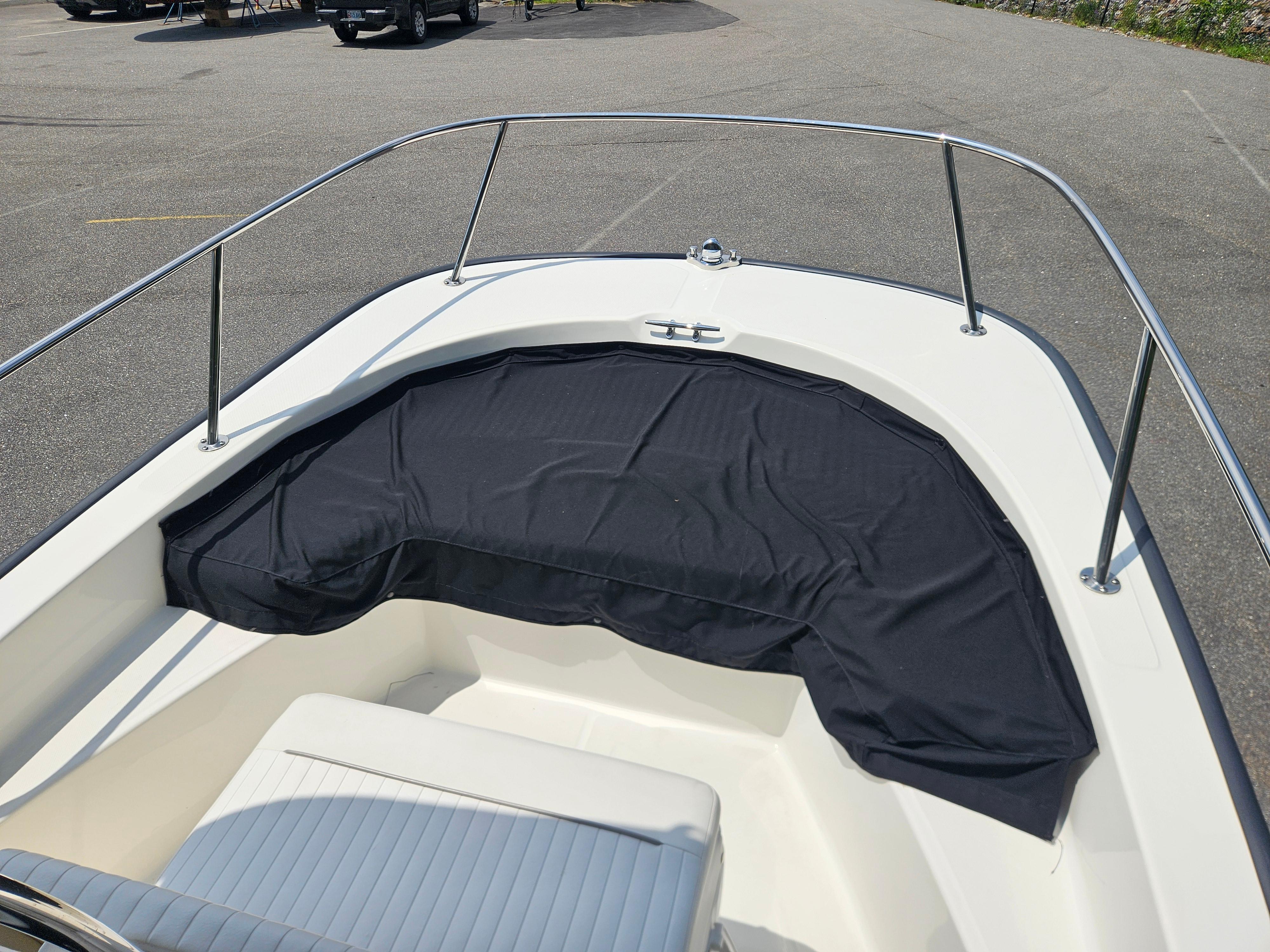 2008 Boston Whaler 170 Montauk boat bow with black cover and railing.