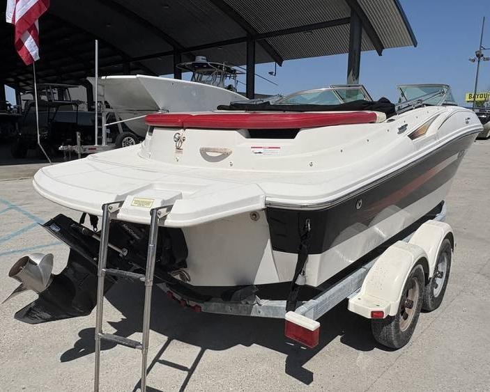 2007 Sea Ray 195 Sport boat on trailer, rear view, parked outdoors.