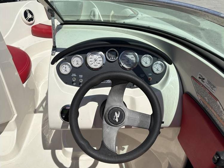 2007 Sea Ray 195 Sport boat dashboard with steering wheel and gauges.