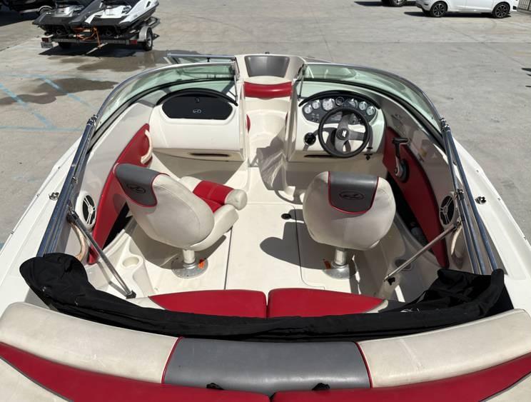 2007 Sea Ray 195 Sport boat interior with red and white seating, steering wheel, and dashboard.