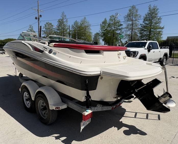2007 Sea Ray 195 Sport boat on trailer, parked outdoors.
