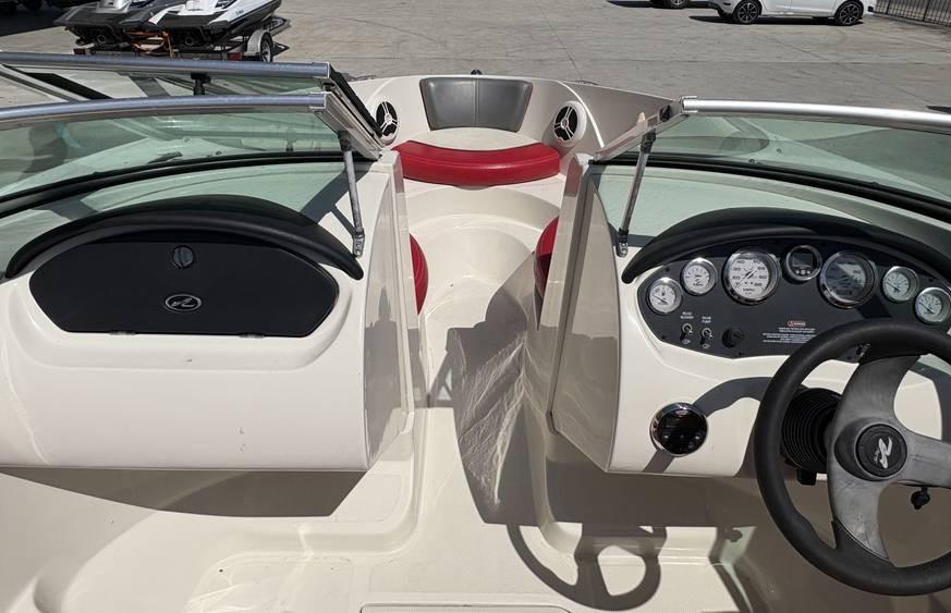 2007 Sea Ray 195 Sport boat interior with red seating and dashboard controls.