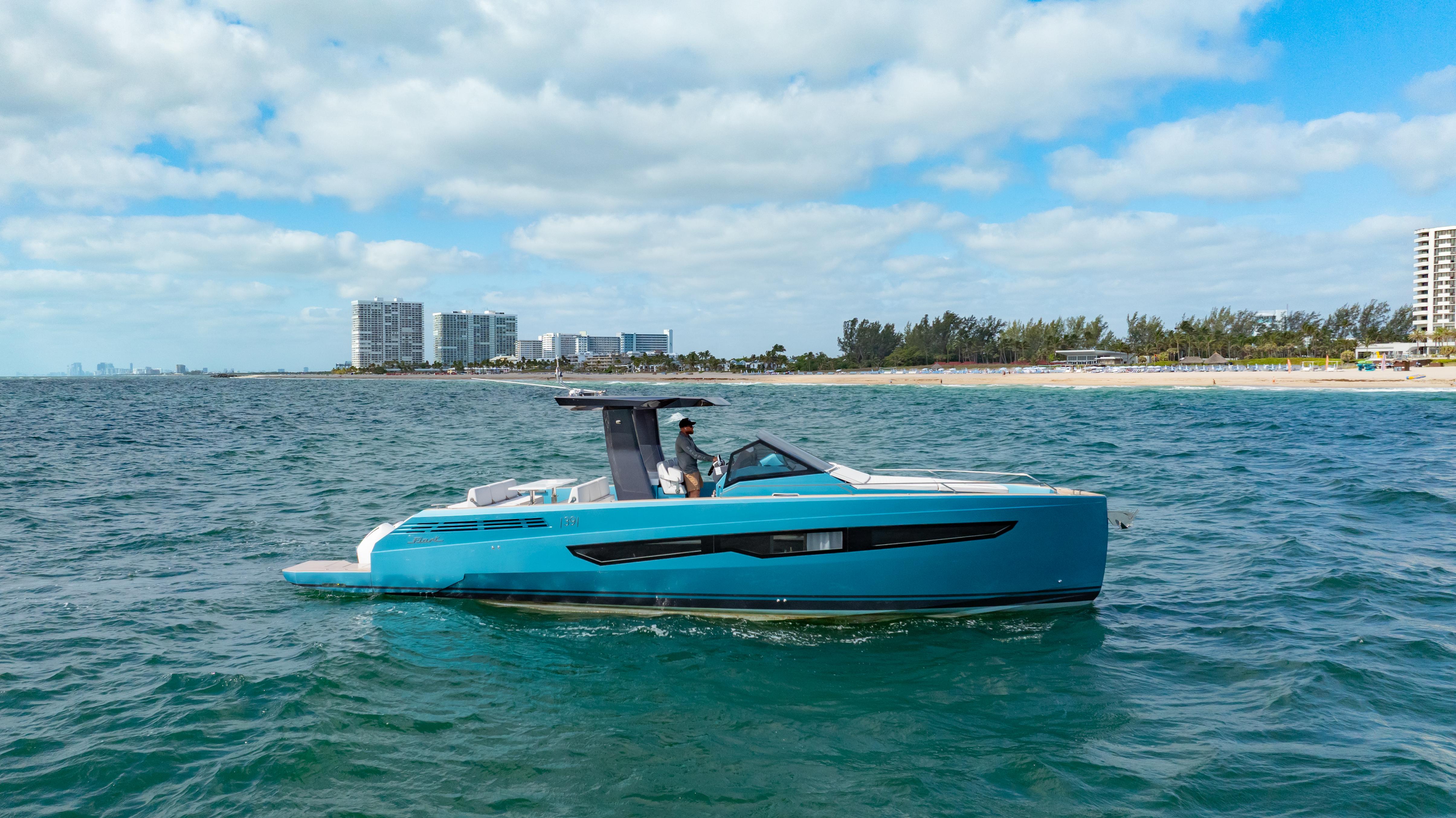 Fiart-39 Seawalker 2024-STRADE BLU FL-US-2024 Fiart 39 Seawalker yacht cruising on open water near a coastal cityscape.-9758537