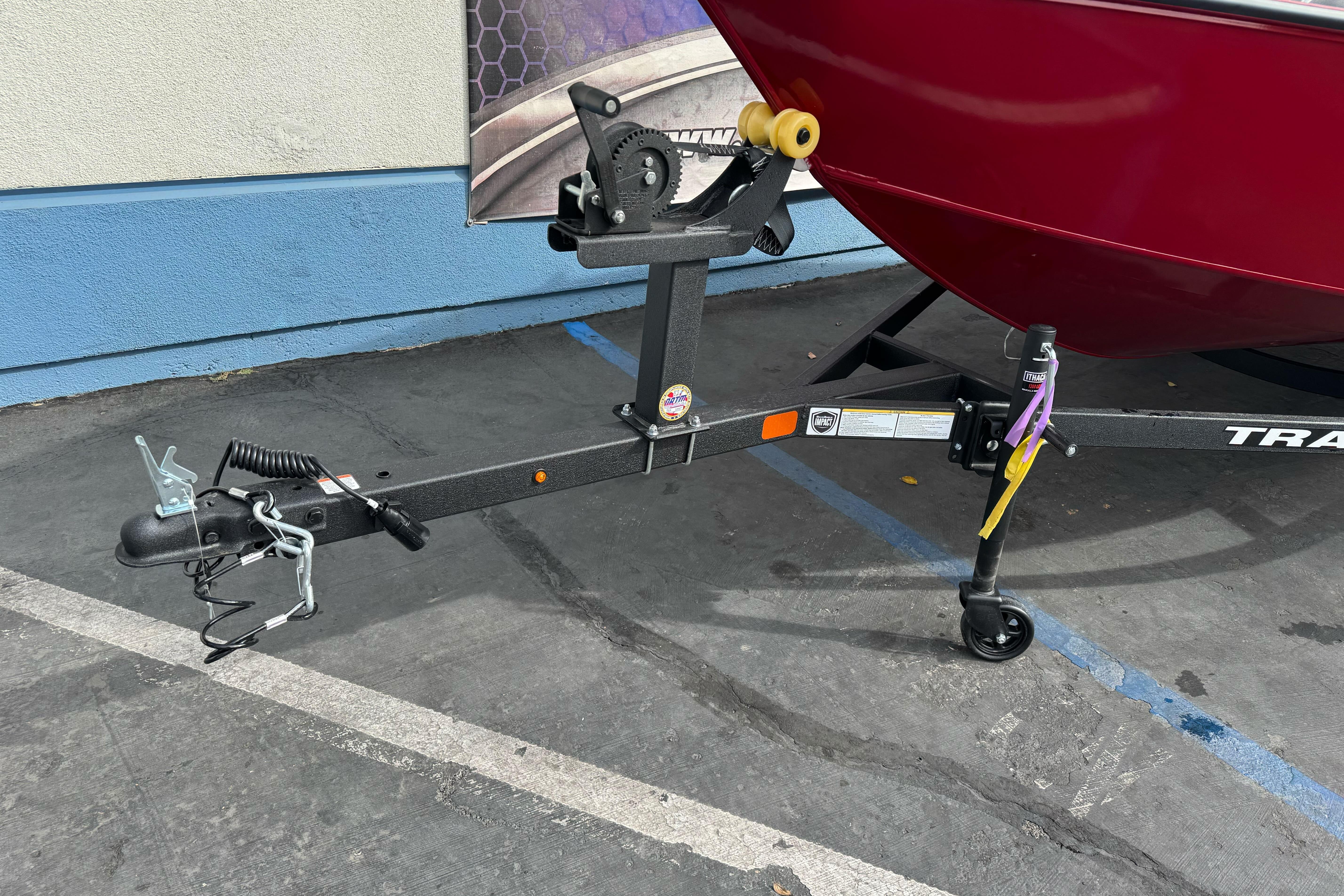 Trailer hitch of 2026 Tracker Super Guide V-16 SC boat, parked on pavement.