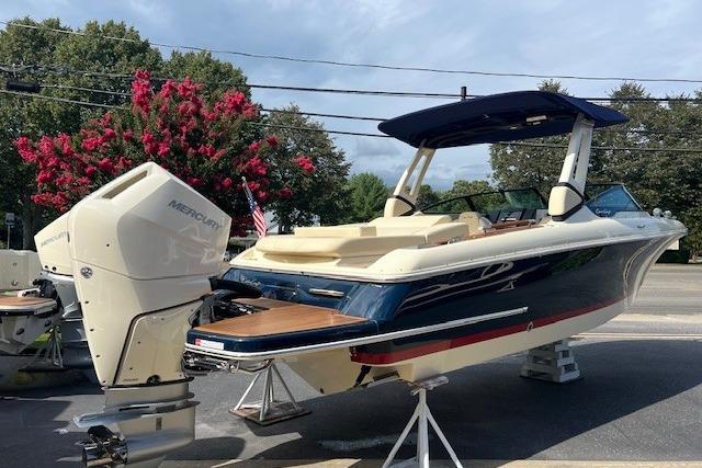 2026 Chris-Craft Sportster 28 boat with Mercury outboard engine, displayed outdoors.