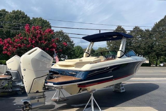 2026 Chris-Craft Sportster 28 boat with dual outboard engines on display outdoors.