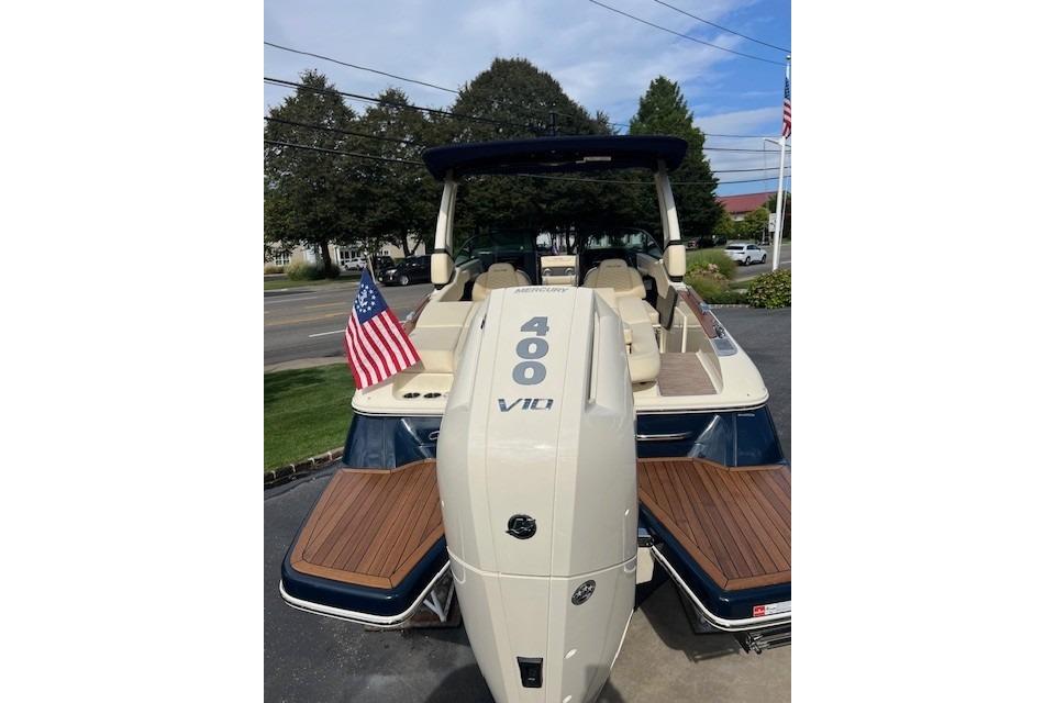 2026 Chris-Craft Sportster 28 with Mercury 400 V10 engine, American flag displayed.
