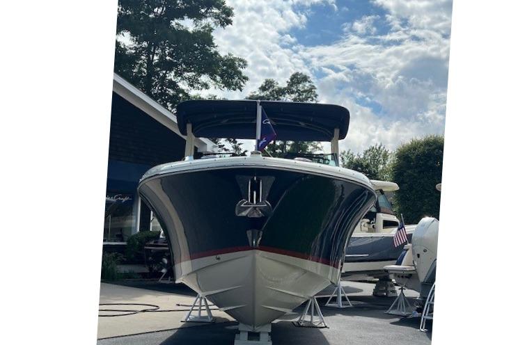 2026 Chris-Craft Sportster 28 boat displayed outdoors under a cloudy sky.