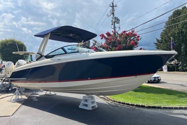 2026 Chris-Craft Sportster 28 boat displayed outdoors on a stand.