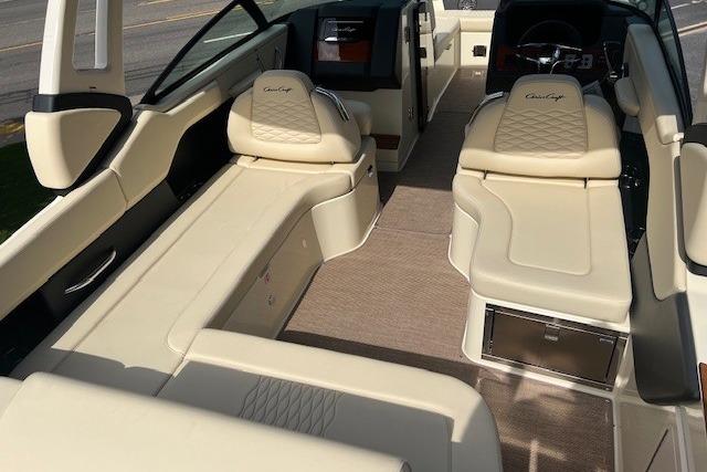 2026 Chris-Craft Sportster 28 interior with luxurious beige seating and modern dashboard.