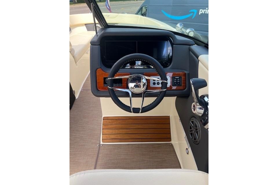 2026 Chris-Craft Sportster 28 dashboard with steering wheel and control panel.