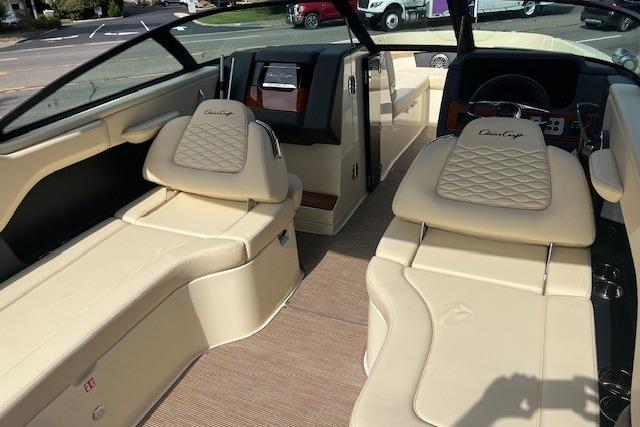 2026 Chris-Craft Sportster 28 interior with luxurious beige seating and modern dashboard.