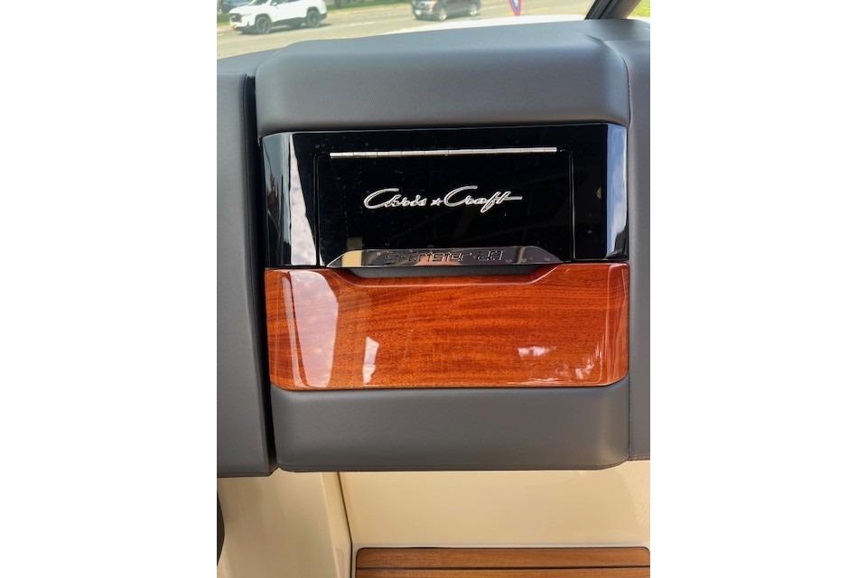Dashboard of 2026 Chris-Craft Sportster 28 with wood and black accents.