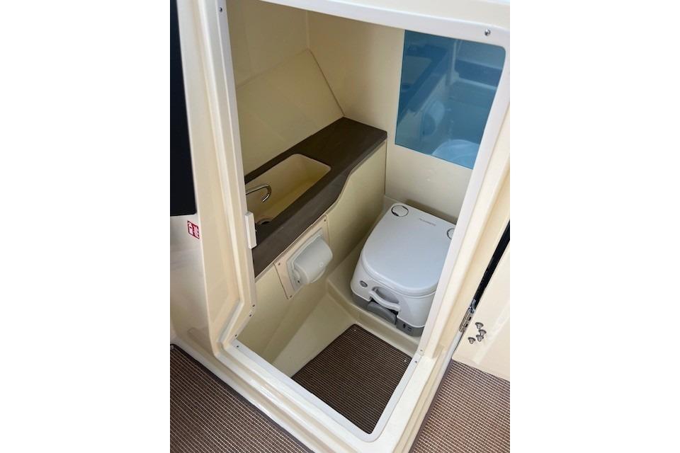 2026 Chris-Craft Sportster 28 boat interior with compact bathroom amenities.