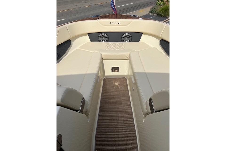 2026 Chris-Craft Sportster 28 interior with beige seating and wood accents.