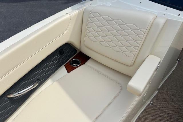 2026 Chris-Craft Sportster 28 interior with elegant cream seating and armrest.