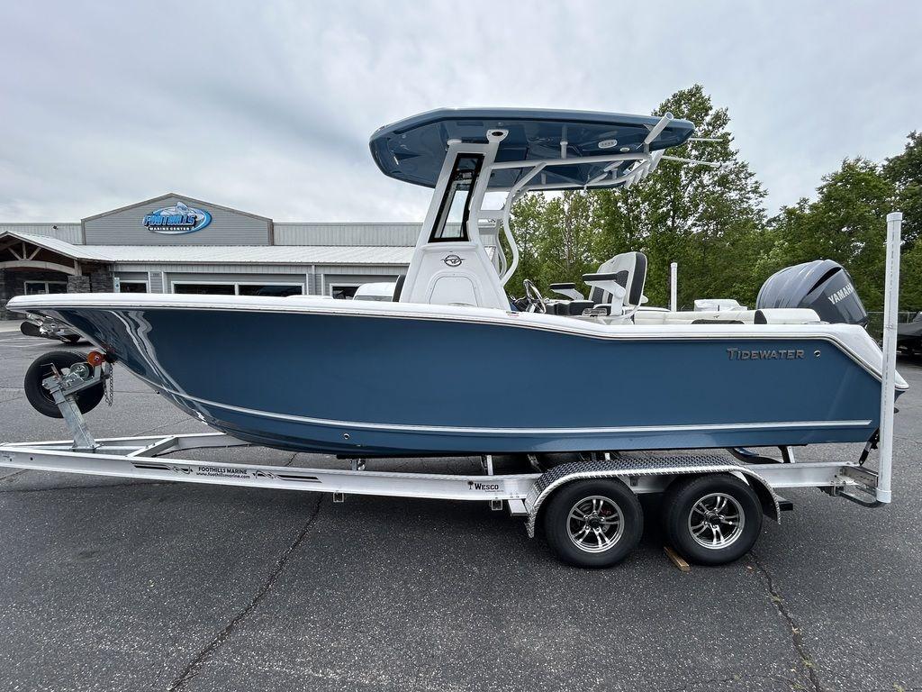 2025 Tidewater 232 LXF boat on trailer, parked outdoors near dealership.