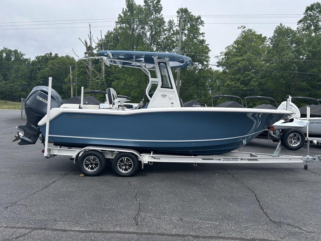 2025 Tidewater 232 LXF boat on trailer, blue hull, parked outdoors.