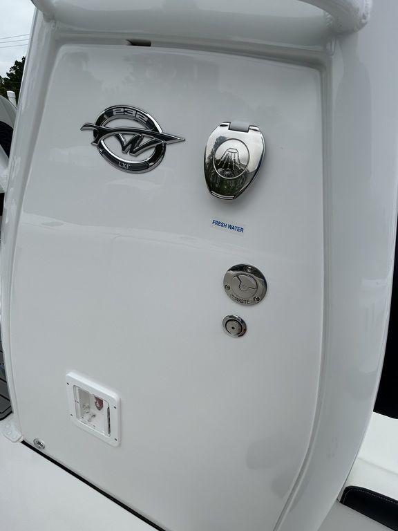 2025 Tidewater 232 LXF boat detail with chrome fixtures and logo.