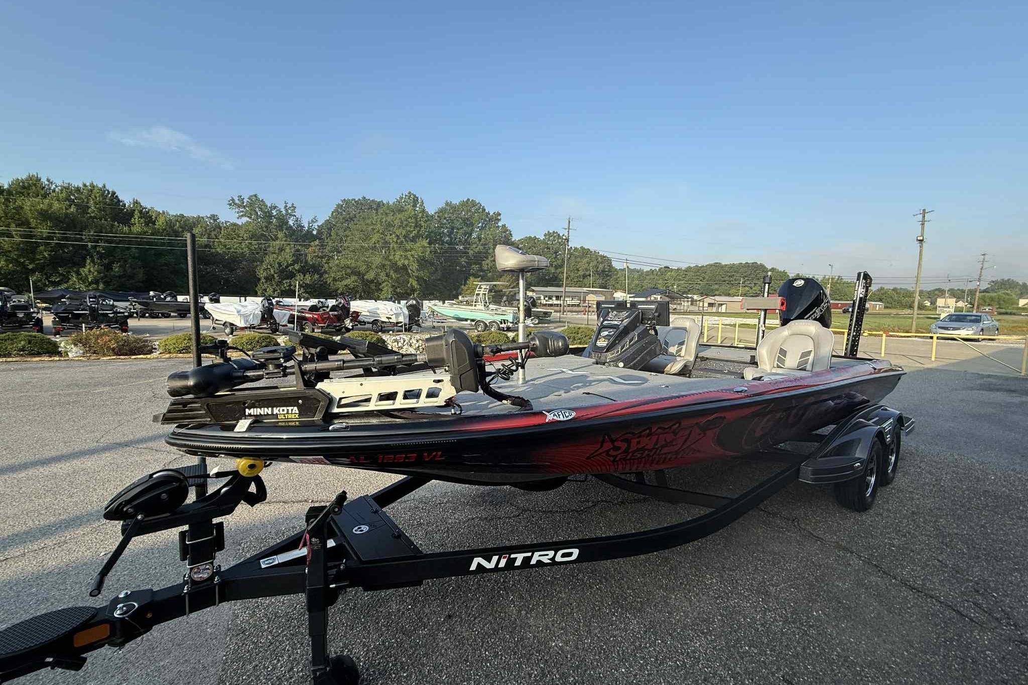 2022 Nitro Z21 XL Pro bass boat on trailer in parking lot.