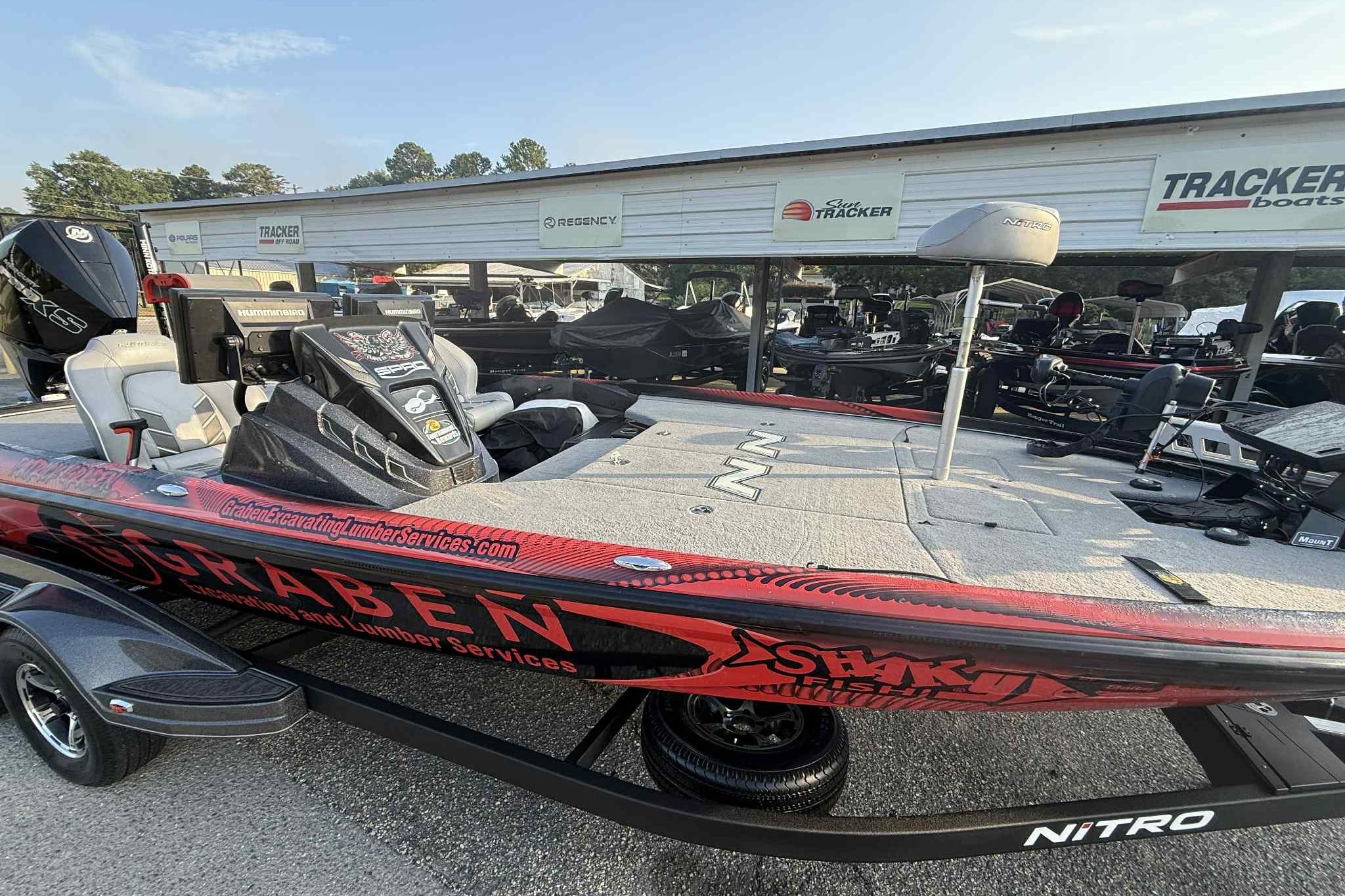 2022 Nitro Z21 XL Pro fishing boat with custom graphics, parked at a dealership.